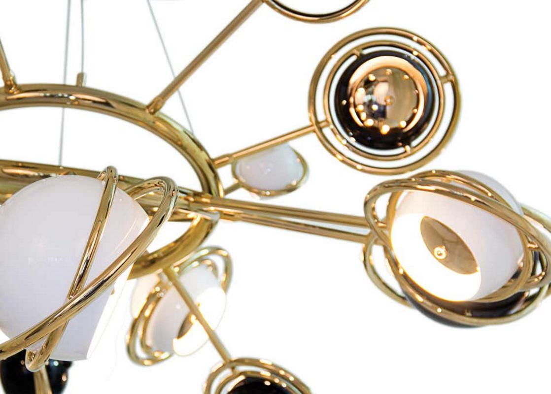 Chandelier is inspired by space, galaxies and the planets that surround us. It is a memorable lighting fixture, with very unique details that make it the luxurious bespoke design piece that it is. Handmade in brass and steel, the body is covered by