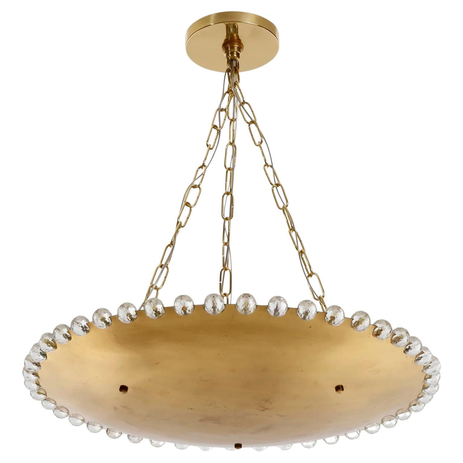 A gorgeous uplight chandelier by Rupert Nikoll, Vienna, Austria, manufactured in Mid-Century, circa 1960 (late 1950s or early 1960s).
A brass bowl made of solid polished brass which has an aged surface in a rich and warm tone and lovely patina.
The