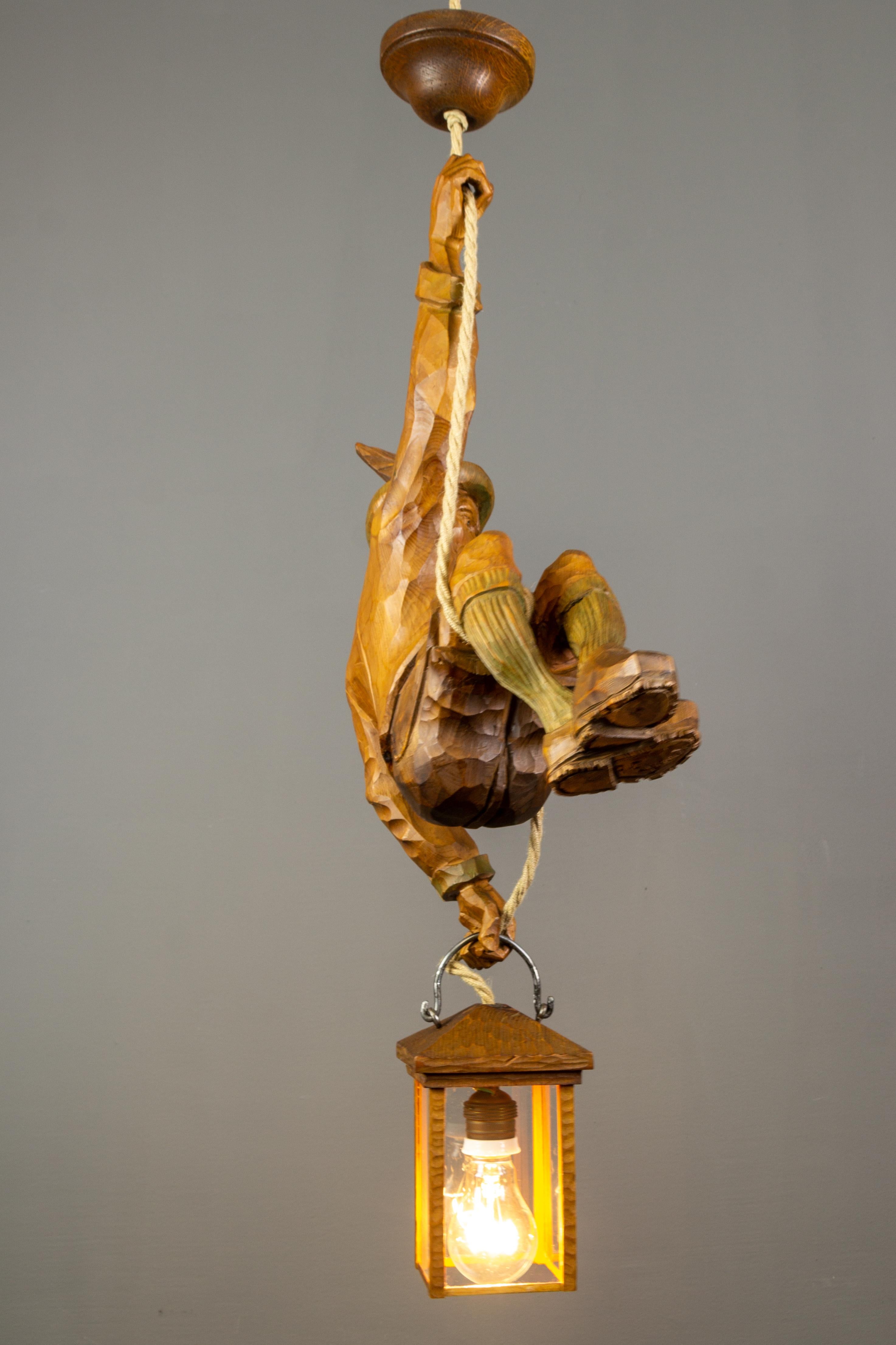 Mid-20th Century Pendant Light with a Large Wooden Figure Mountain Climber with Lantern, Germany For Sale