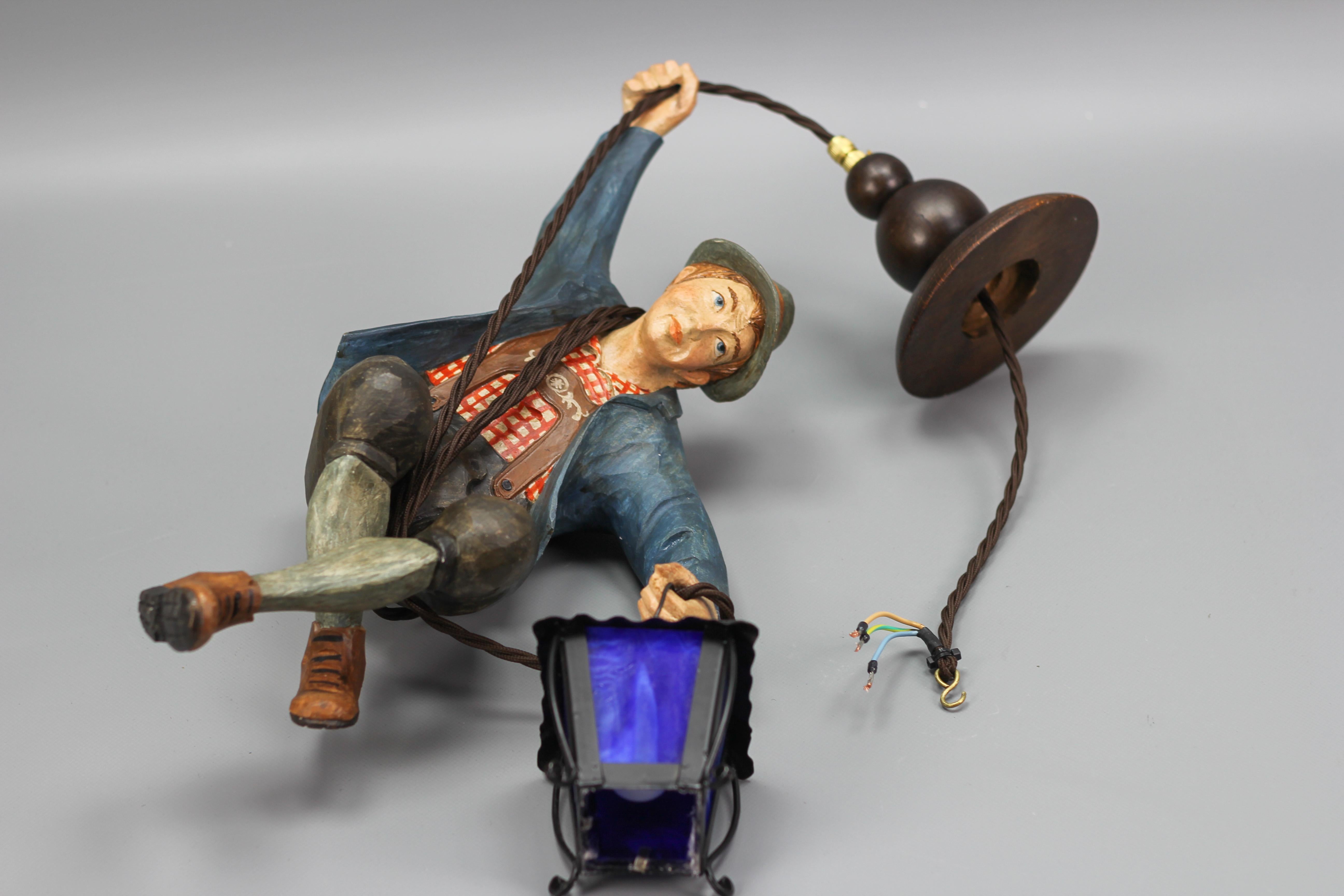 Pendant Light with Figure of a Mountain Climber and a Blue Glass Lantern For Sale 1