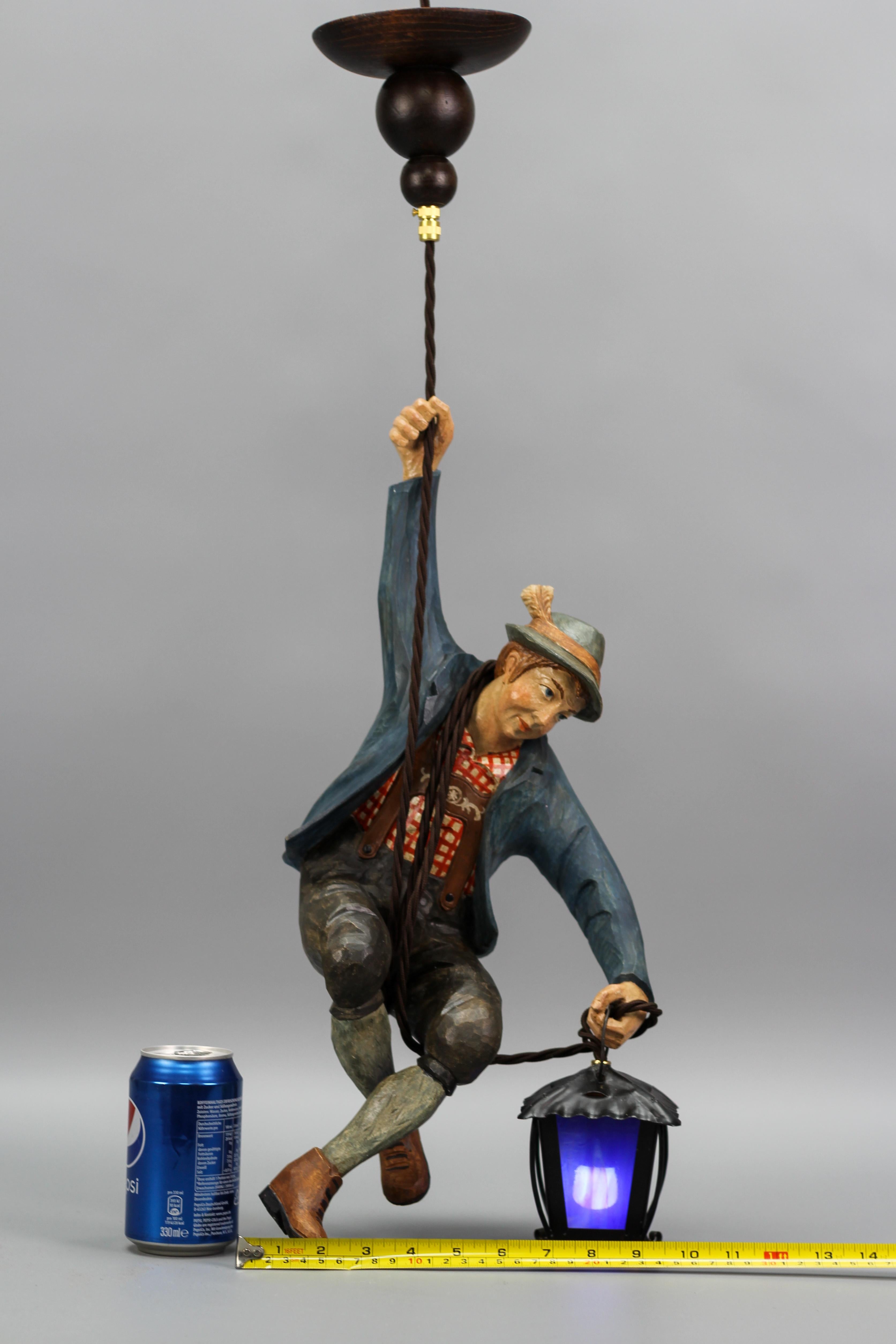 Pendant Light with Figure of a Mountain Climber and a Blue Glass Lantern For Sale 9