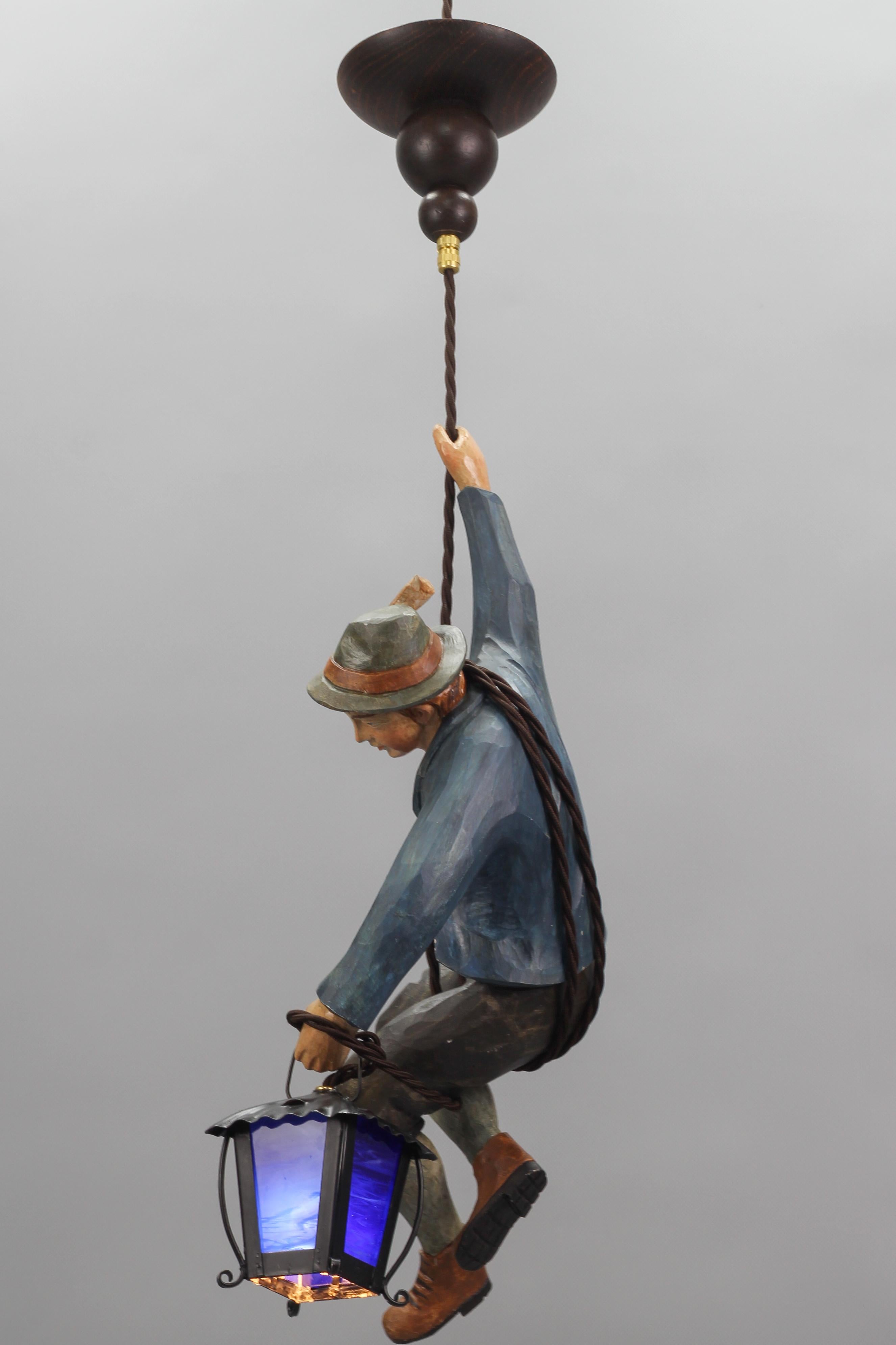 Allemand Lampe suspendue avec une figure d'un rameur de montagne et une lanterne en verre bleu en vente