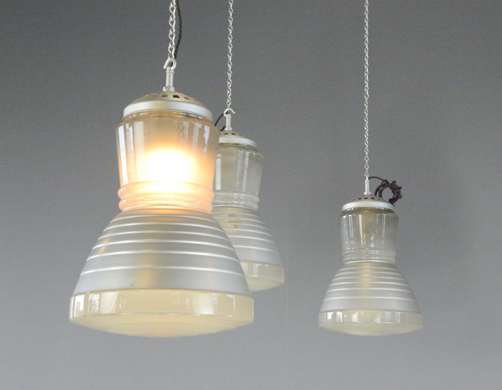 Pendant Lights By Adolf Meyer For Zeiss Ikon Circa 1930s

- Price is per light (10 available)
- Moulded glass with mercury inner reflectors
- Takes E27 fitting bulbs
- Comes with 150cm of black twist cable and silver chain
- Designed by Adolf