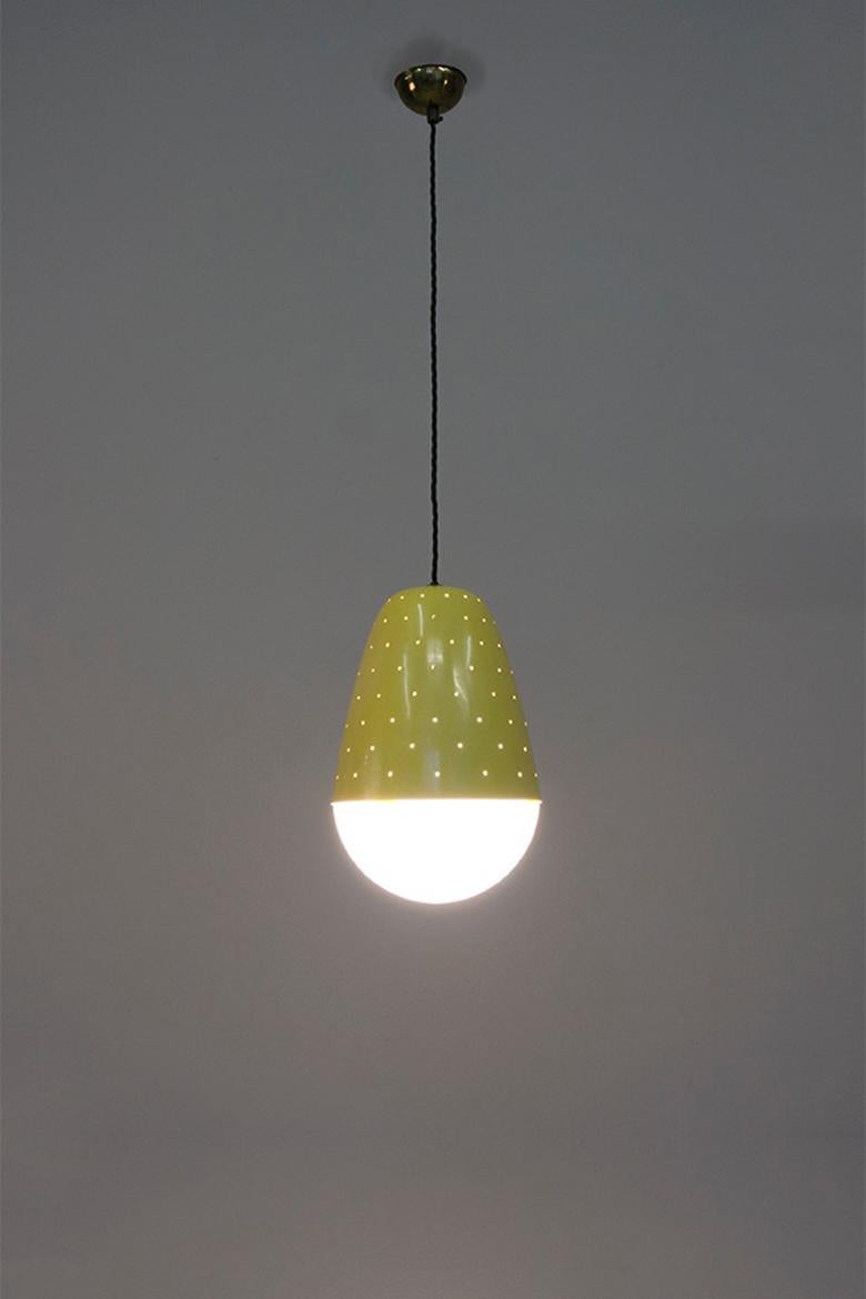 Pendant lights model no. '2079' with a perforated yellow lacquered metal construction and opaline glass. 

Dimensions: H. 30 cm Ø20 cm 
Design: Gino Sarfatti 1955
Manufacturer: Arteluce Italy

Cf. Gino Sarfatti, MarCo Romanelli, Sandra Severi, 1938