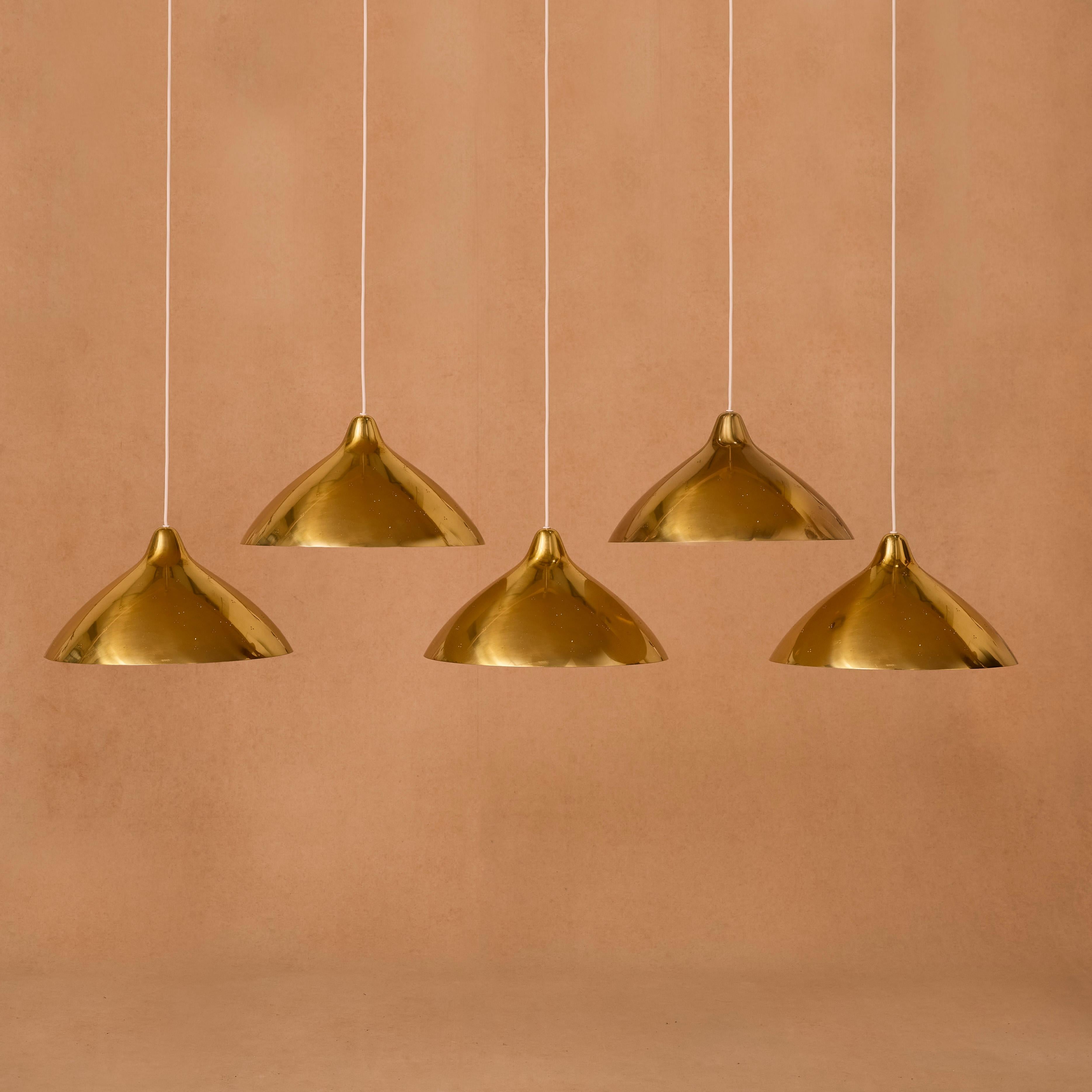 Large telescope pendant lights in perforated brass, designed by Lisa Johansson-Pape. 
 