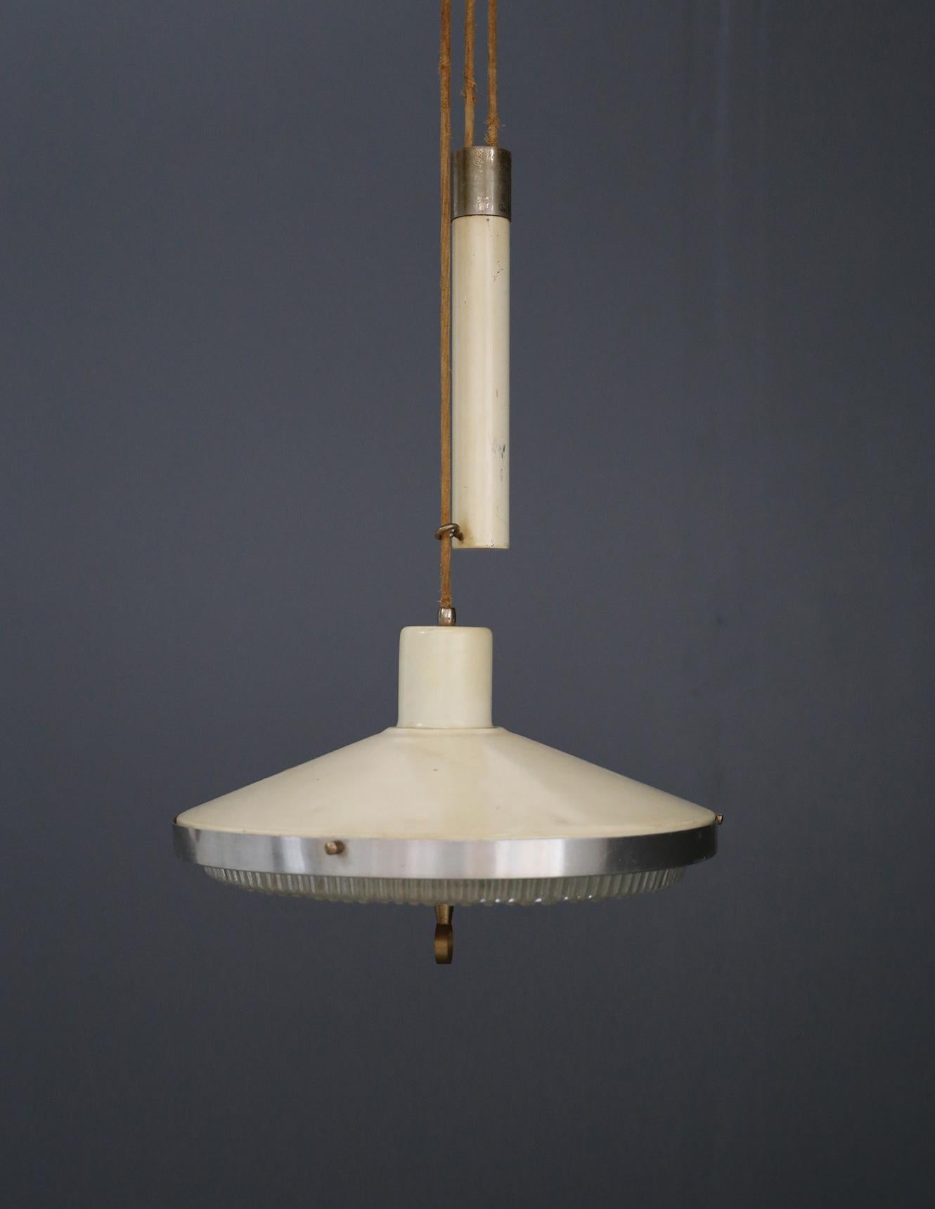 Eccentric vintage design ups and downs from the 1950s. The pendant also called ups and downs because of its counterweight mechanism that allows the lamp to go up and down at will. The pendant comes from Italian administrative offices.
The