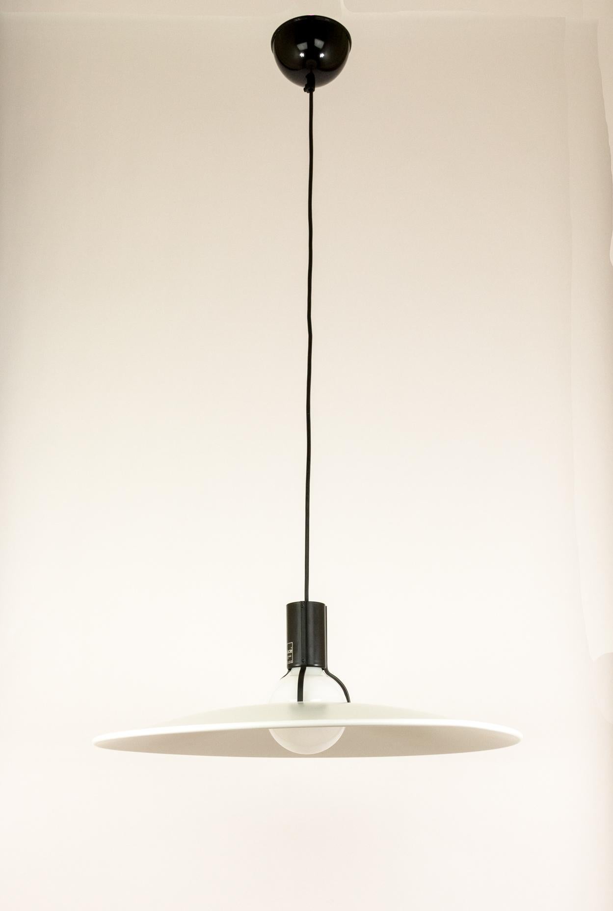 A beautifully balanced pendant, Model 2133, by Gino Sarfatti and produced by Arteluce in Italy.

According to Marco Romanelli and Sandra Severi in their standard work on Gino Sarfatti: “Reflective aluminium plate lacquered white on the bottom