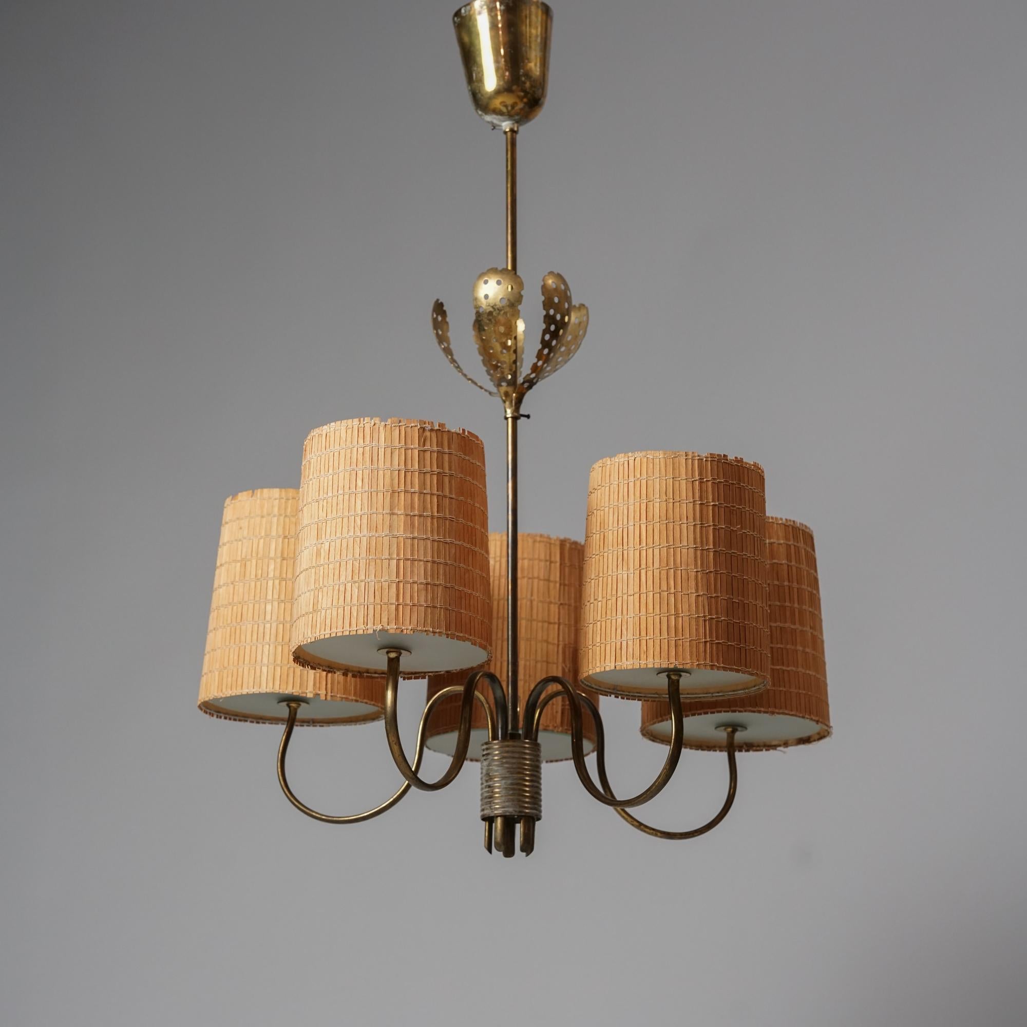 Pendant model 9030 designed by Paavo Tynell for Taito Oy. From the  1940s/1950s. Brass frame with glass and rattan lampshades. Good vintage condition, minor patina consistent with age and use. Classic Scandinavian Modern piece by Paavo Tynell. 