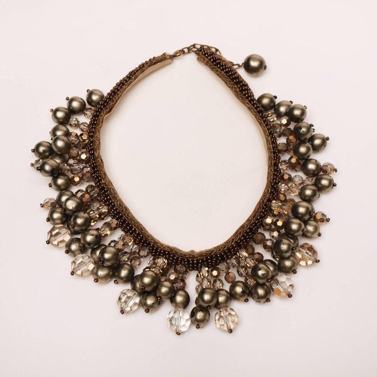 1950's statement necklace festooned with paste stones and faux pearls supported on a cloth backed collar of bronzed alloy beads and gilt wire. Nacre coating has been worn in places on the pearls. Supposedly once in the wardrobe of Peggy Guggenheim.