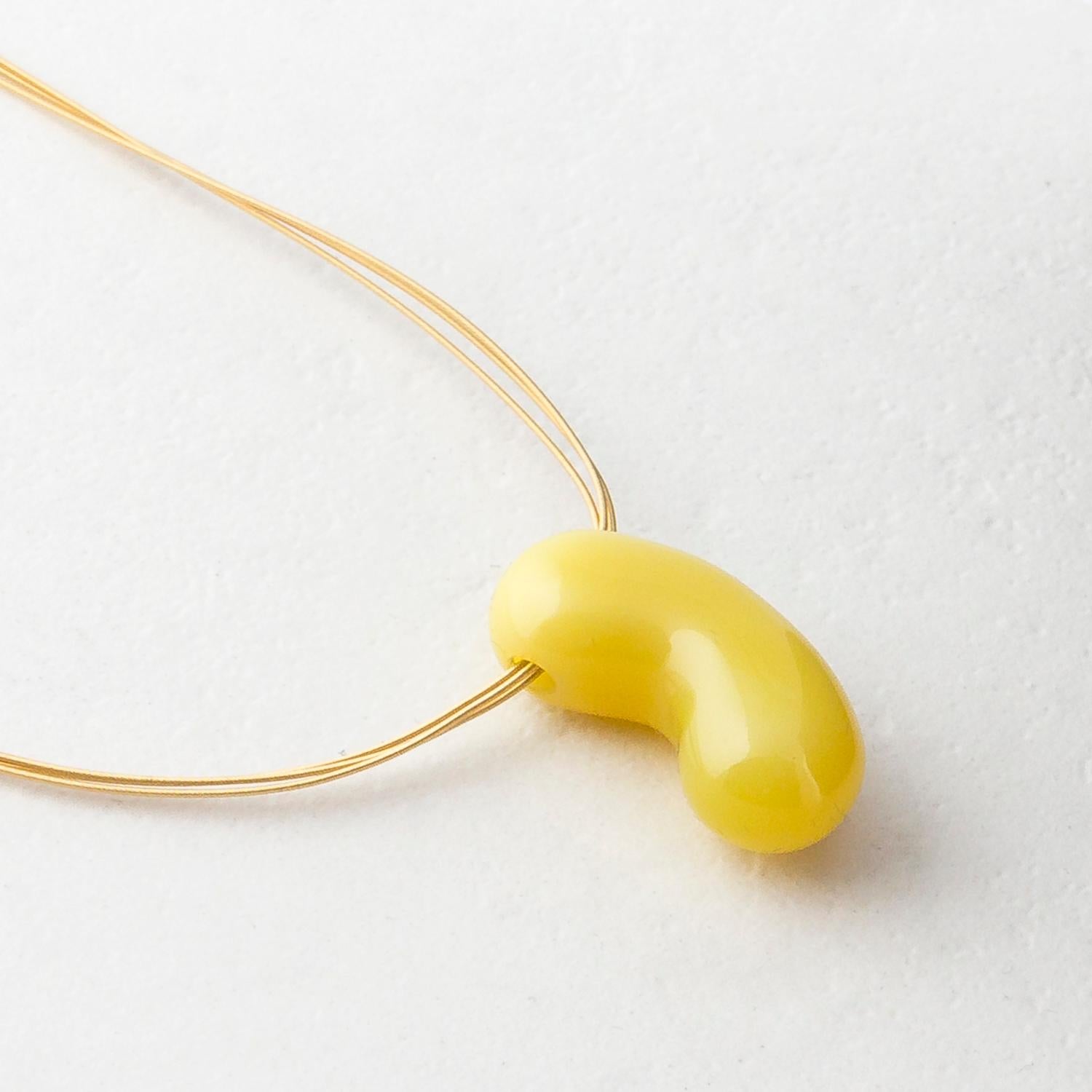 Hand-carved by Dieter Lorenz, one of the top names in contemporary gem-carving, this yellow agate jellybean pendant is hung on an 18 Karat Yellow Gold multi strand necklace.

Made by hand in our family run Northern Irish jewellery workshop. Inspired