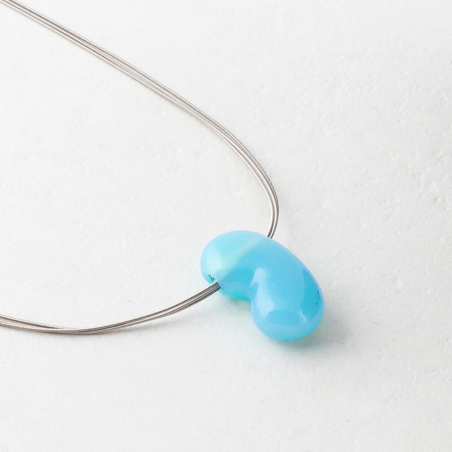 Handcarved by Dieter Lorenz, one of the top names in contemporary gem-carving, this turquoise agate jellybean pendant is hung on an 18 Karat White Gold multi strand necklace.

Made by hand in our family run Northern Irish jewellery workshop.