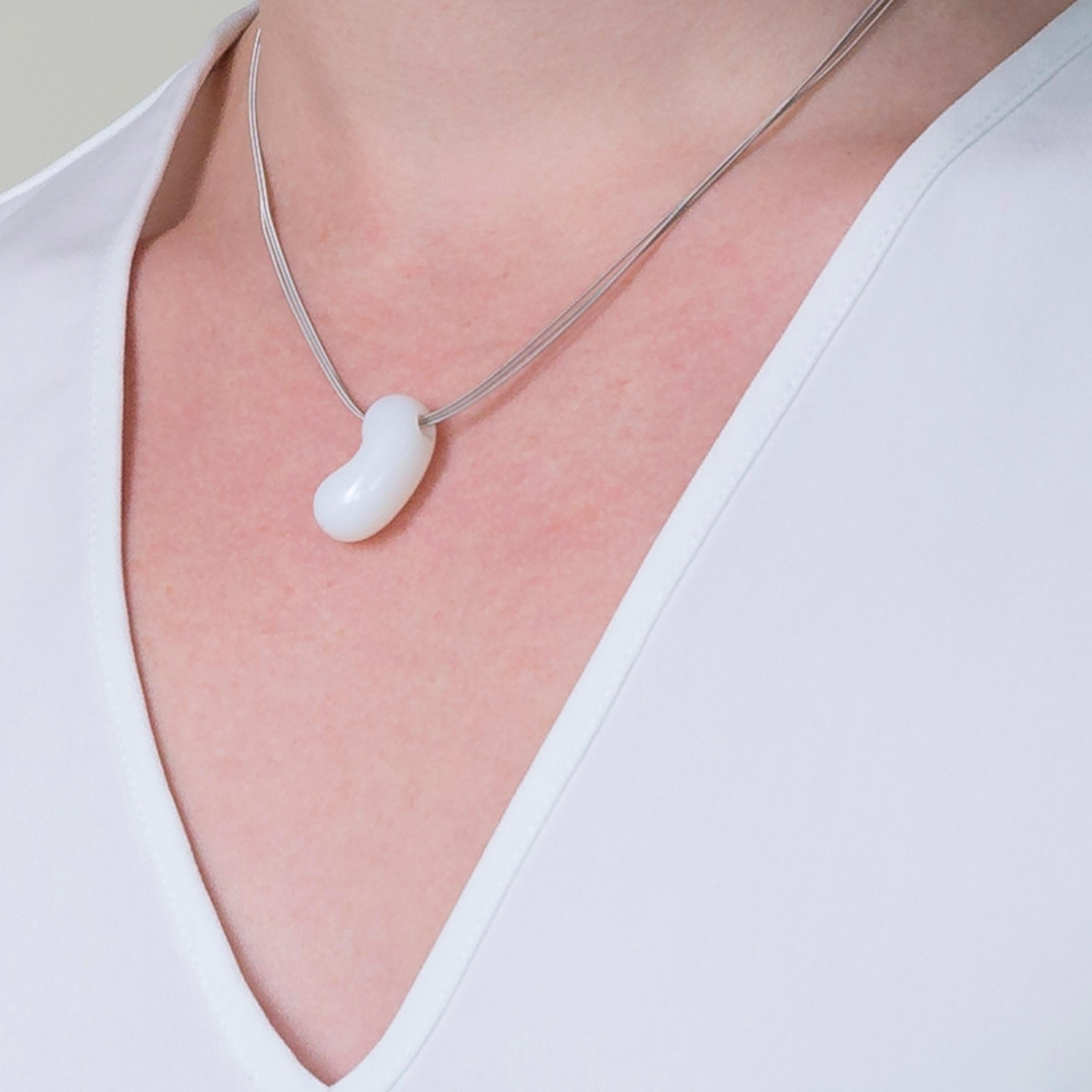 Handcarved by Dieter Lorenz, one of the top names in contemporary gem-carving, this semi-translucent white agate jellybean pendant is hung on an 18 Karat White Gold multi strand necklace.

Made by hand in our family run Northern Irish jewellery