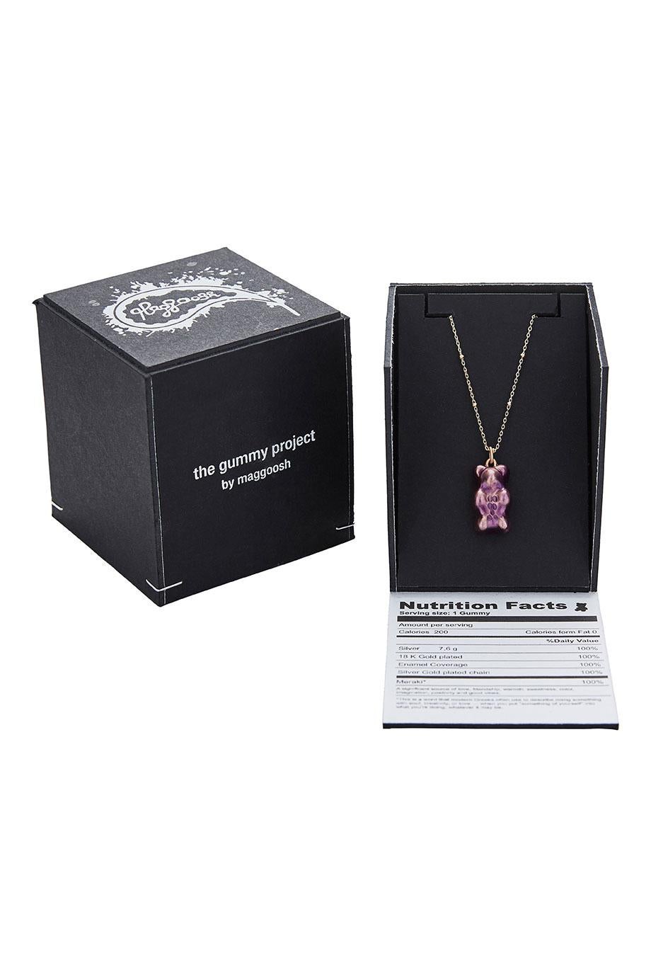 18K gold plated silver gummy bear pendant on silver gold plated chain with transparent black enamel coverage. 

The Gummy Project by Maggoosh is a capsule collection inspired by the designer's life in New York City and her passion for breakdancing