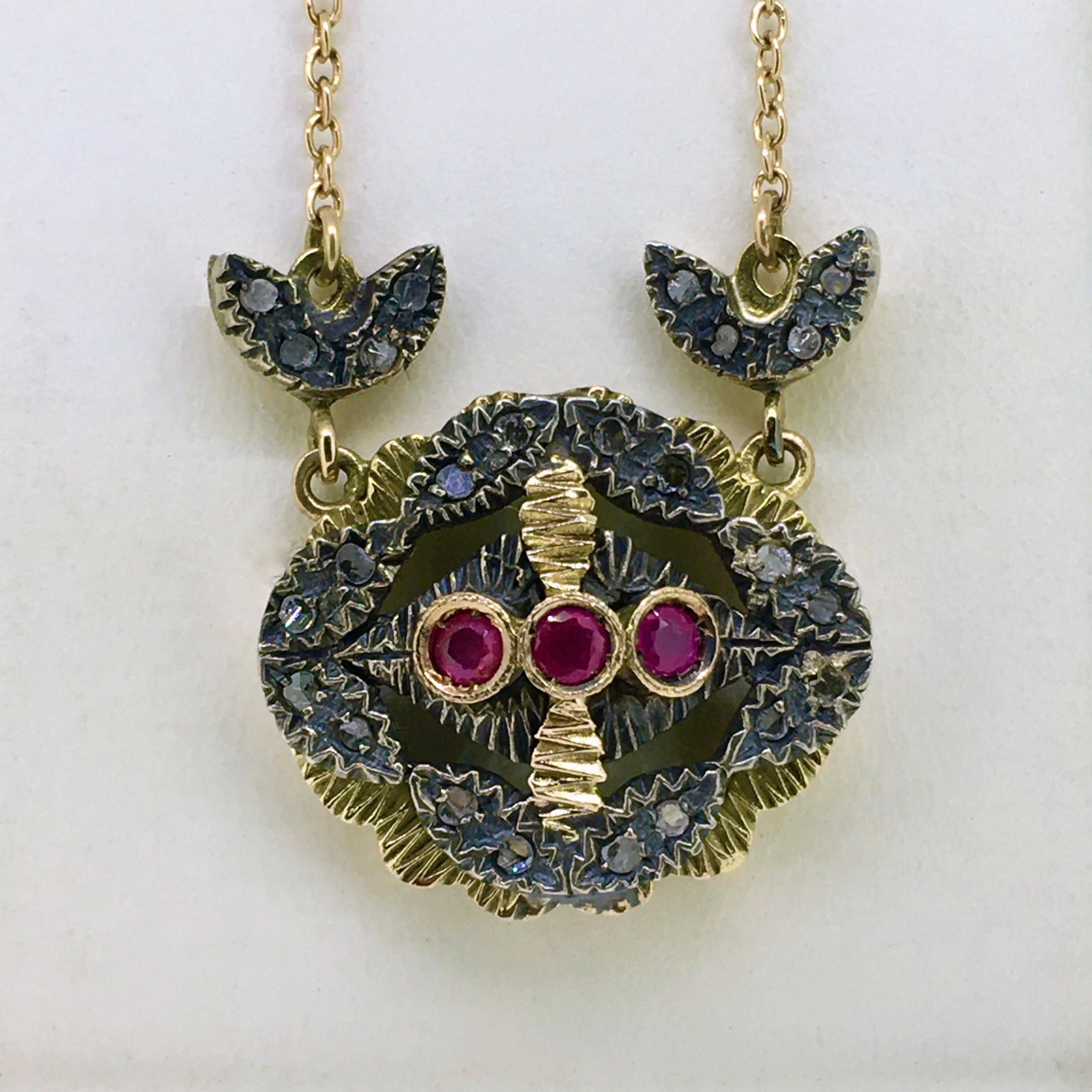 Antique Pendant Necklace, 12 carat yellow gold set with 3 rubies, the silver aplique is set with old mine cut diamonds. This lovely pendant has its original chain necklace. The length is 42 cm. The overall condition of this pendant necklace is very
