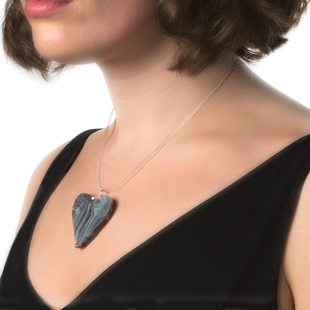 Embellished with a round cut, solitaire diamond, suspended from a 3-strand White Gold necklace, this Druzy Chalcedony stone has been carved into a simple, naturalistic heart shape. It has subtle bands of grey beneath the shimmering druzy