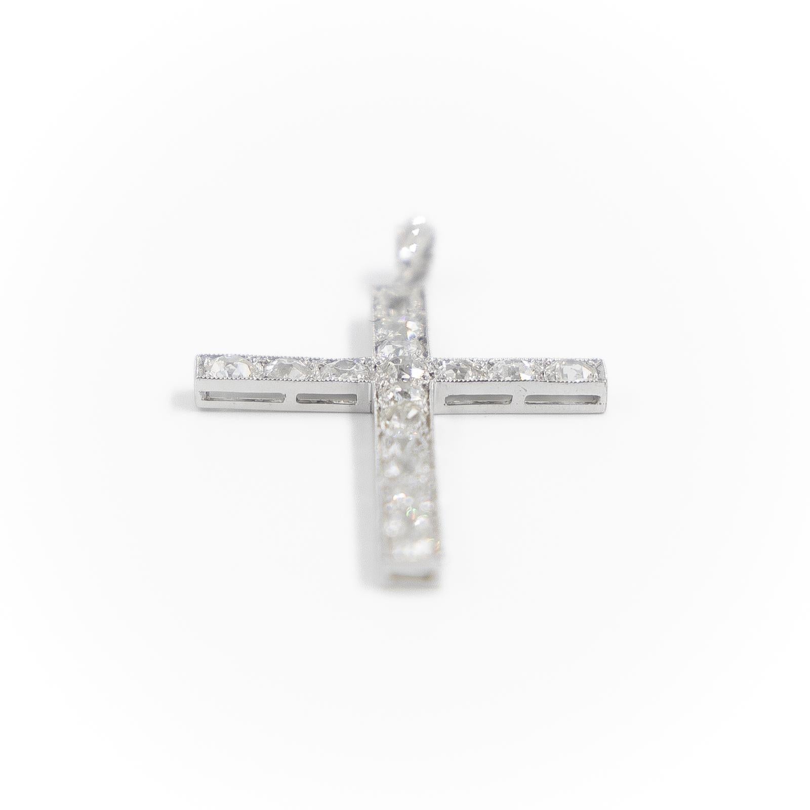 Pendant in platinum 900 thousandths. representing a catholic cross. set with 20 diamonds. 17 of them old cut of about 0.10 ct each. and 3 rose cut diamonds on the setting. 2 of about 0.01 ct each and one of about 0.03 ct. Length: 4.45 cm. Width: