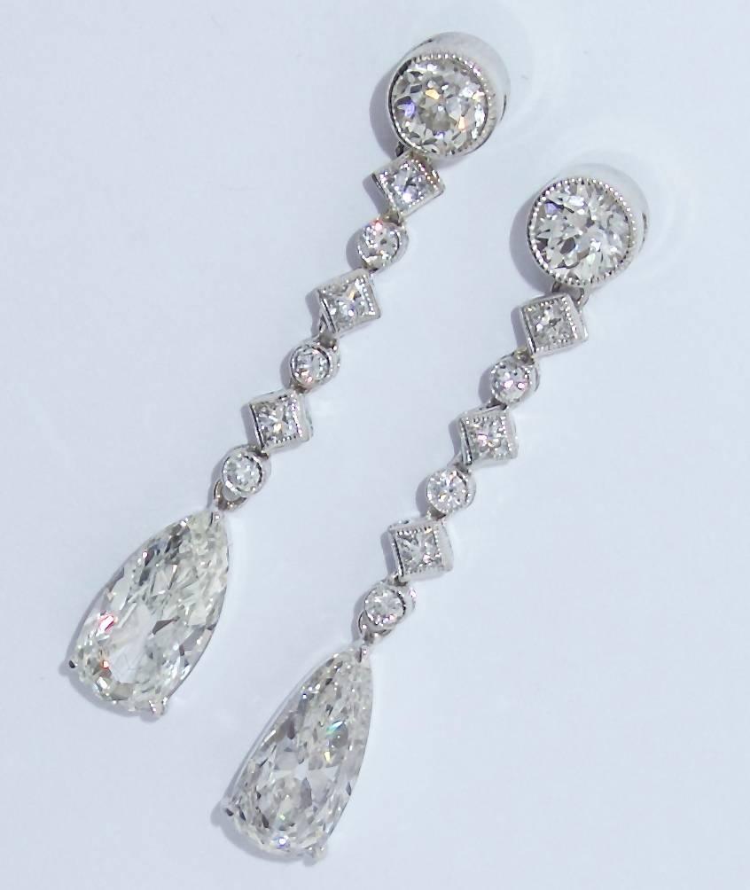 Four and one half carats of fine white diamonds including a pair of well cut graceful pear (3.5 cts.) cut diamonds that shimmer as the lady moves.  There are 16 round brilliant cut, early pear cut, and square cut diamonds.  These stones are H/I