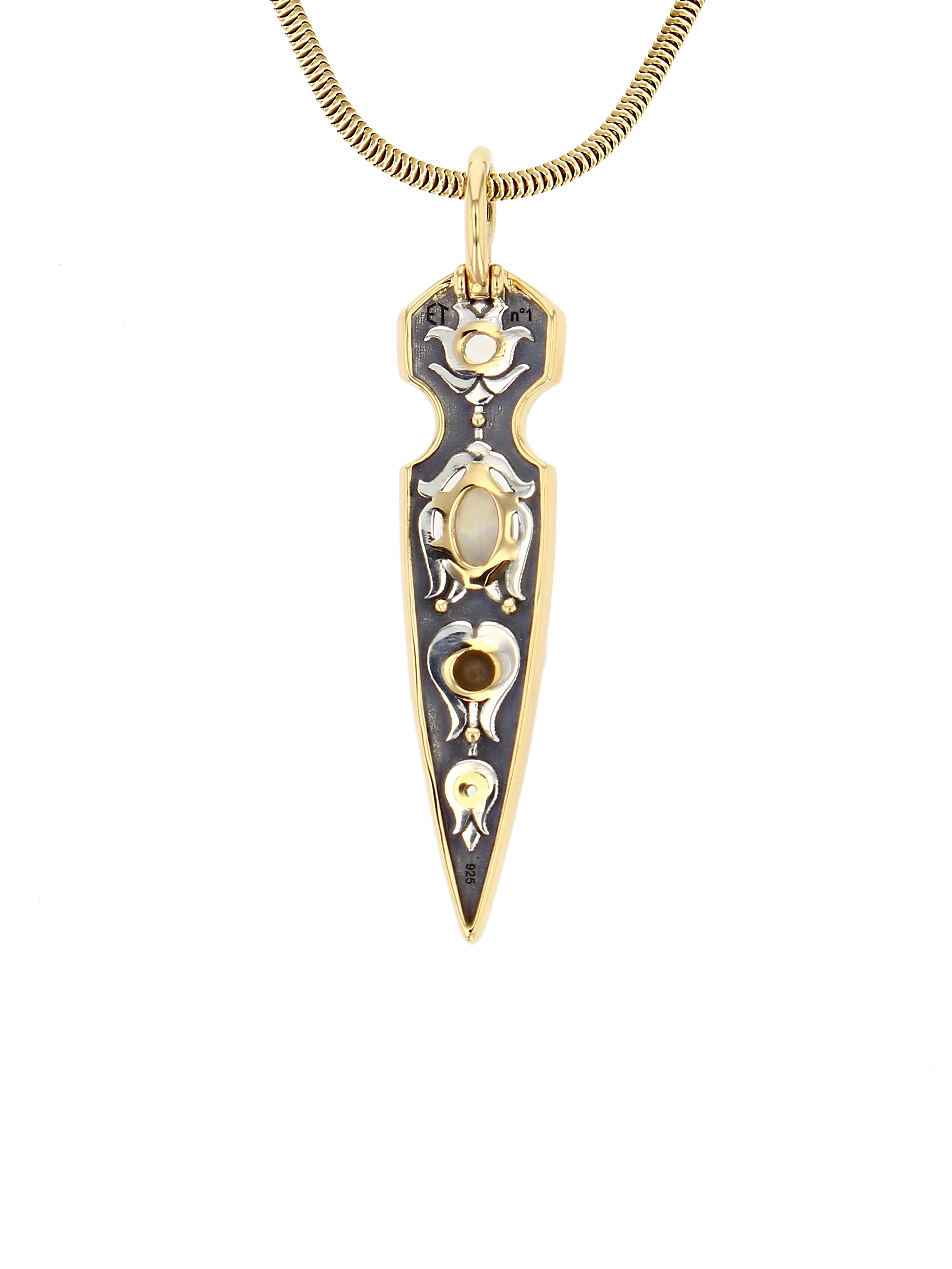 Yellow gold and distressed silver pendant,  studded with opal, akoya pearls and white topazes.

Details:
Opal, Topaz et Akoya Pearls
18k Yellow Gold: 7.6 g
Distressed Silver: 2 g
Made in France
