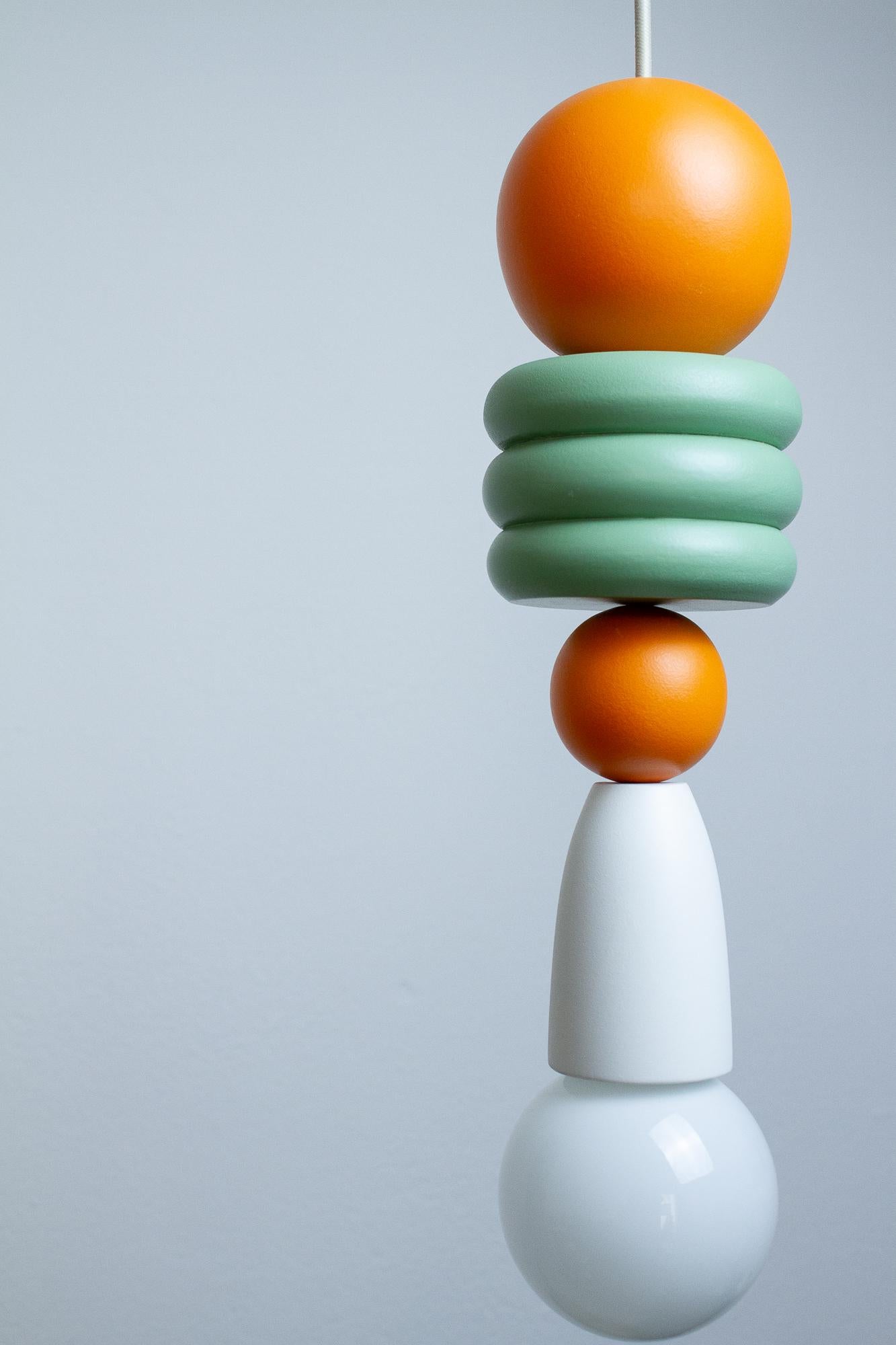 La lampe Trem das Cores 5 fait partie de la collection du même nom. Cette Collection comprend 4 lampes qui combinent les couleurs et les formes du bois pour illuminer les maisons du monde entier. Conçues par Raísa Anderson, créatrice chez Pirilampa,