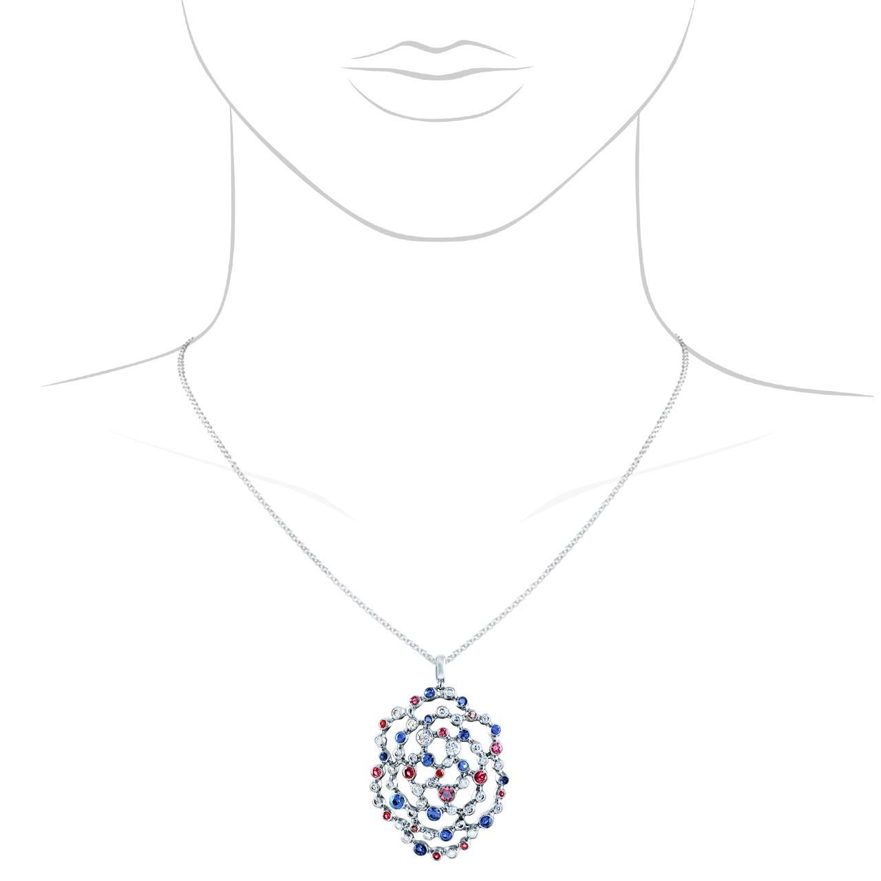- 35 Round Diamonds - 1,015 ct, G/VVS1-VVS2
- 16 Round Rubies - 0,69 ct
- 14 Round Sapphires - 0,71 ct
- 18K White Gold 
- Weight: 8,34 g
This elegant pendant from the Byzantium collection is encrusted with 1,015 ct of diamonds, 0,71 ct of sapphires