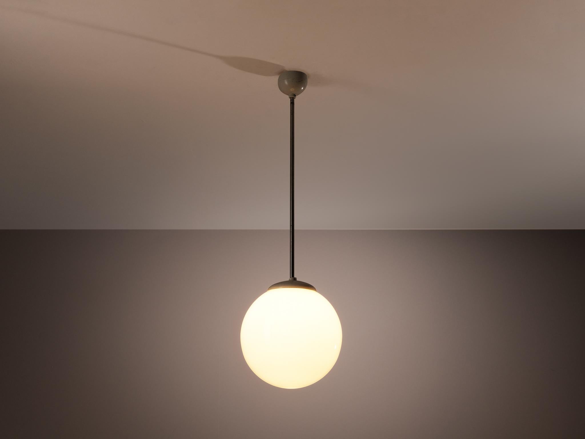 Pendant, opaline glass, metal, plastic, Europe, 1960s.

Clean and simple pendant lamp with opaline glass sphere, metal rod and plastic detailing. The lamp can be hung above a dining table as a set or in an entranceway in order to make an
