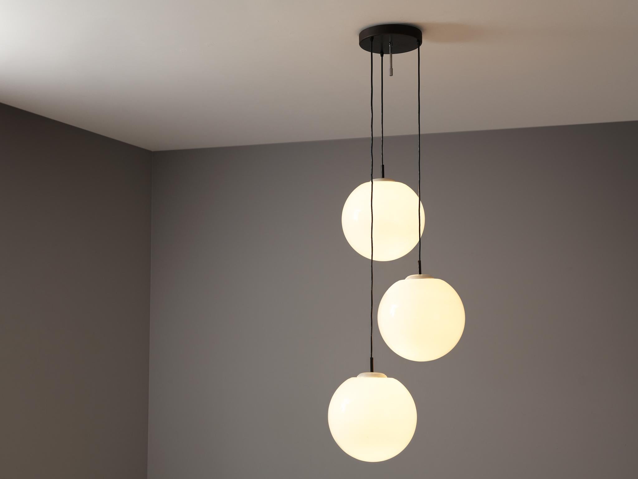 Pendant with three spheres, glass, lacquered metal, Europe, 1960s

A sophisticated composition of three large spheres in white glass are arranged in a spiral form. Each shade is suspended by a sleek, black wire and attached to a round ceiling