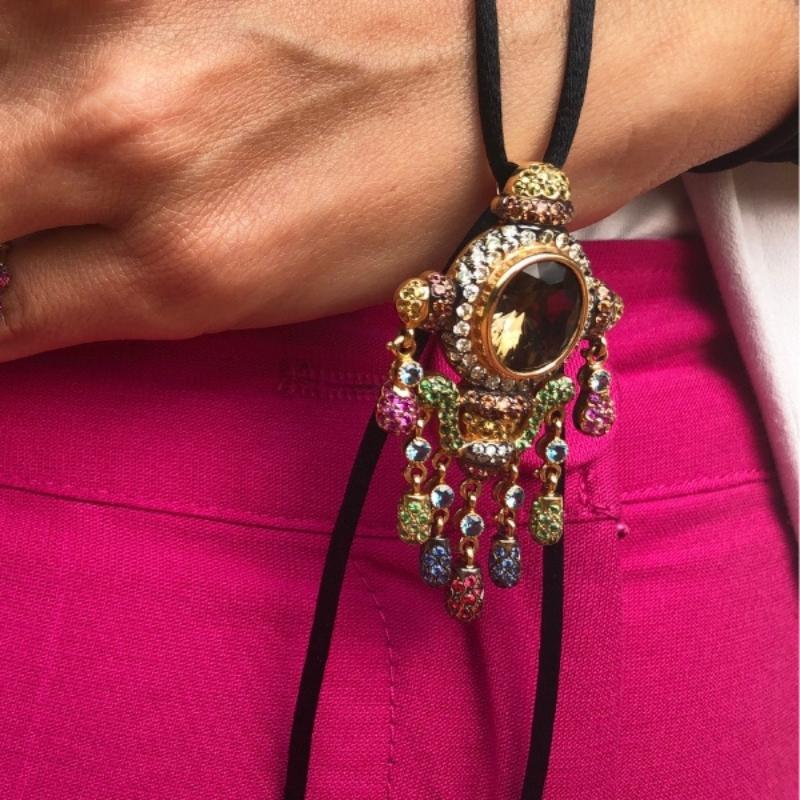 Pendant Zorab with silk ribbon and gold.
1 centre oval cut Smoky quartz
39 yellow sapphires
58 orange sapphires,
55 diamonds 
30 pink sapphires 
52 blue sapphires
7 blue sapphires
86 green sapphires
31 red sapphires