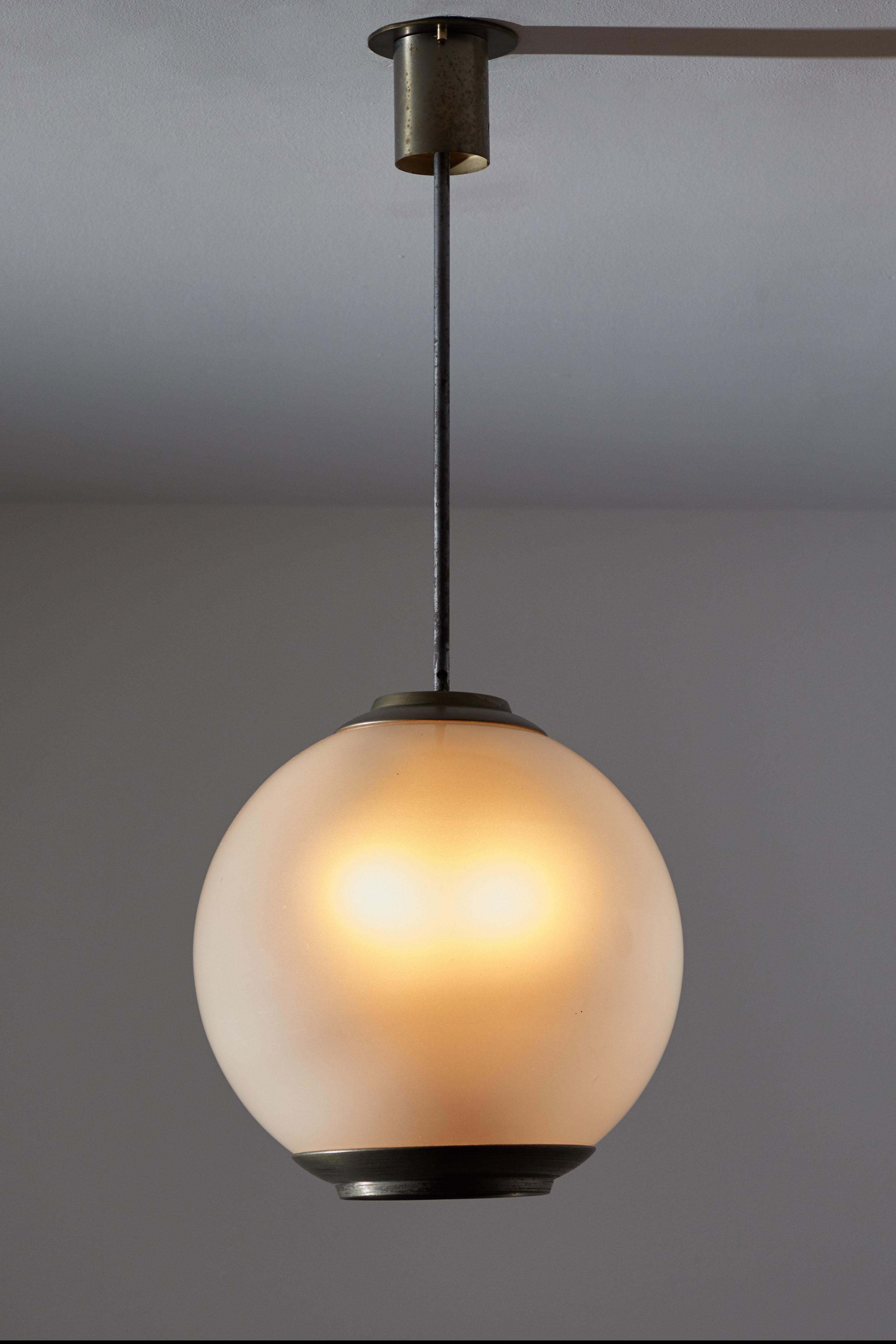 Single Pendant by Caccia Dominioni for Azucena. Designed and manufactured in Italy, circa 1950s. Opaline glass diffusers, steel stem and canopy, pewter hardware. Rewired for US junction boxes. Custom nickel plated brass ceiling plate. Each pendant