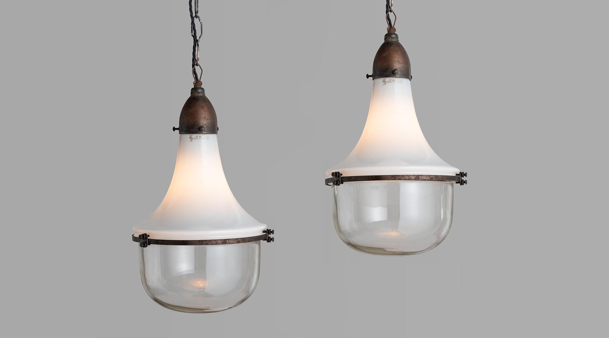 Two part pendant with opaline and clear glass shades, with copper brace and fitter.



Measures: 9.5