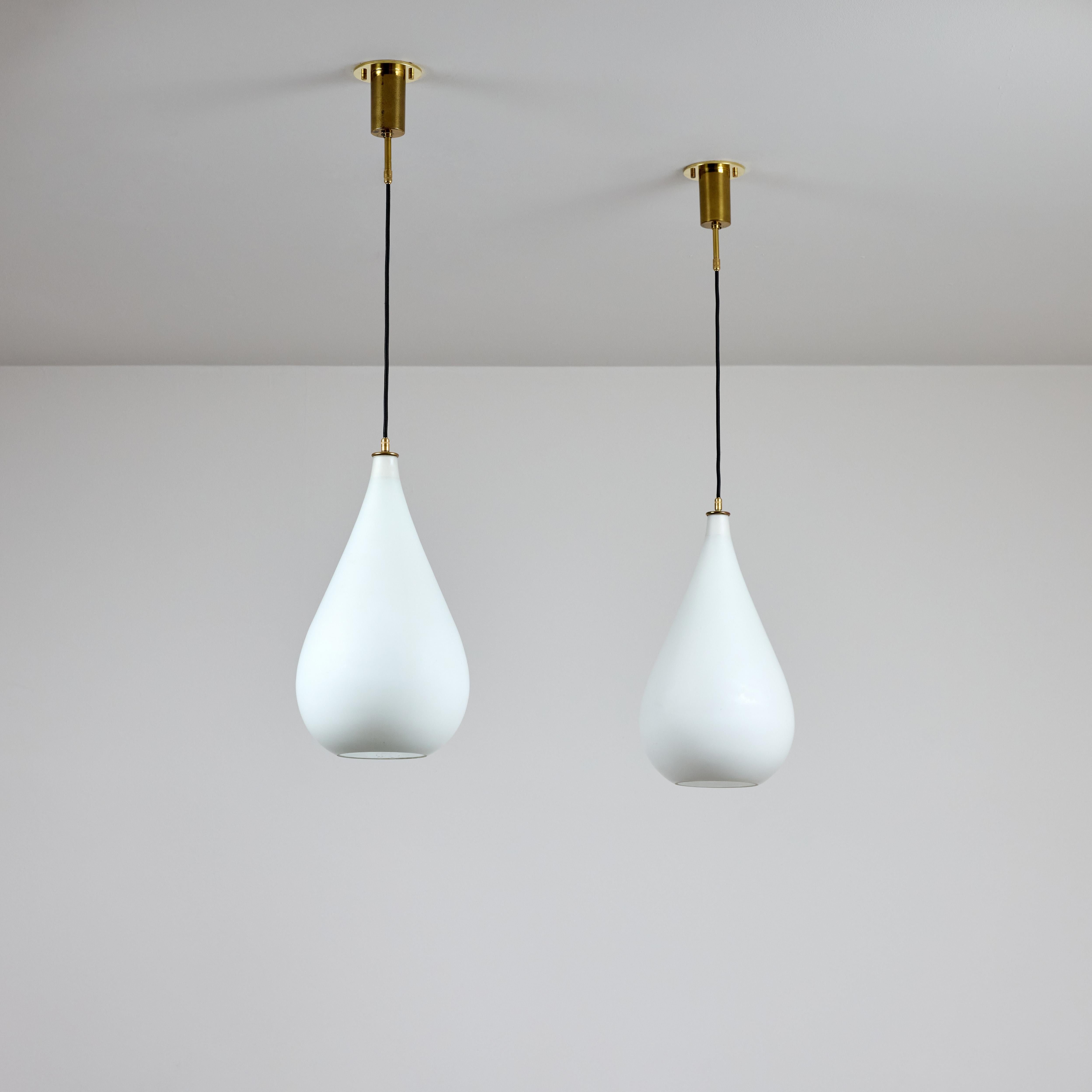 Pendants by Stilnovo (IT, c. 1960s)

White opaline teardrop pendants and a bottom relief cirlce for lower illumination. Each pendant holds a single E27 socket-type, adapted for the US. We recommend a 40-60w max bulb or LED equivalent. Sold