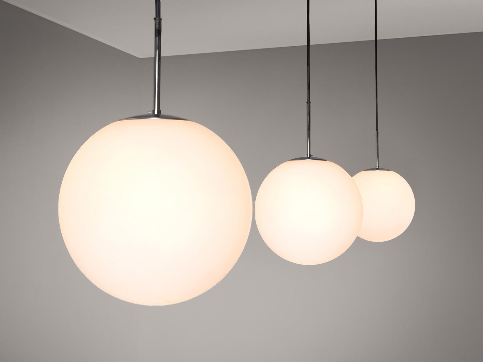 Pendants, opaline glass, metal, Europe 1970s. 

Set of modern pendants with white opaline glass globe shaped spheres. overall, an elegant but simplistic design with a globe shaped sphere. Due the opaline glass and the light point, these pendants