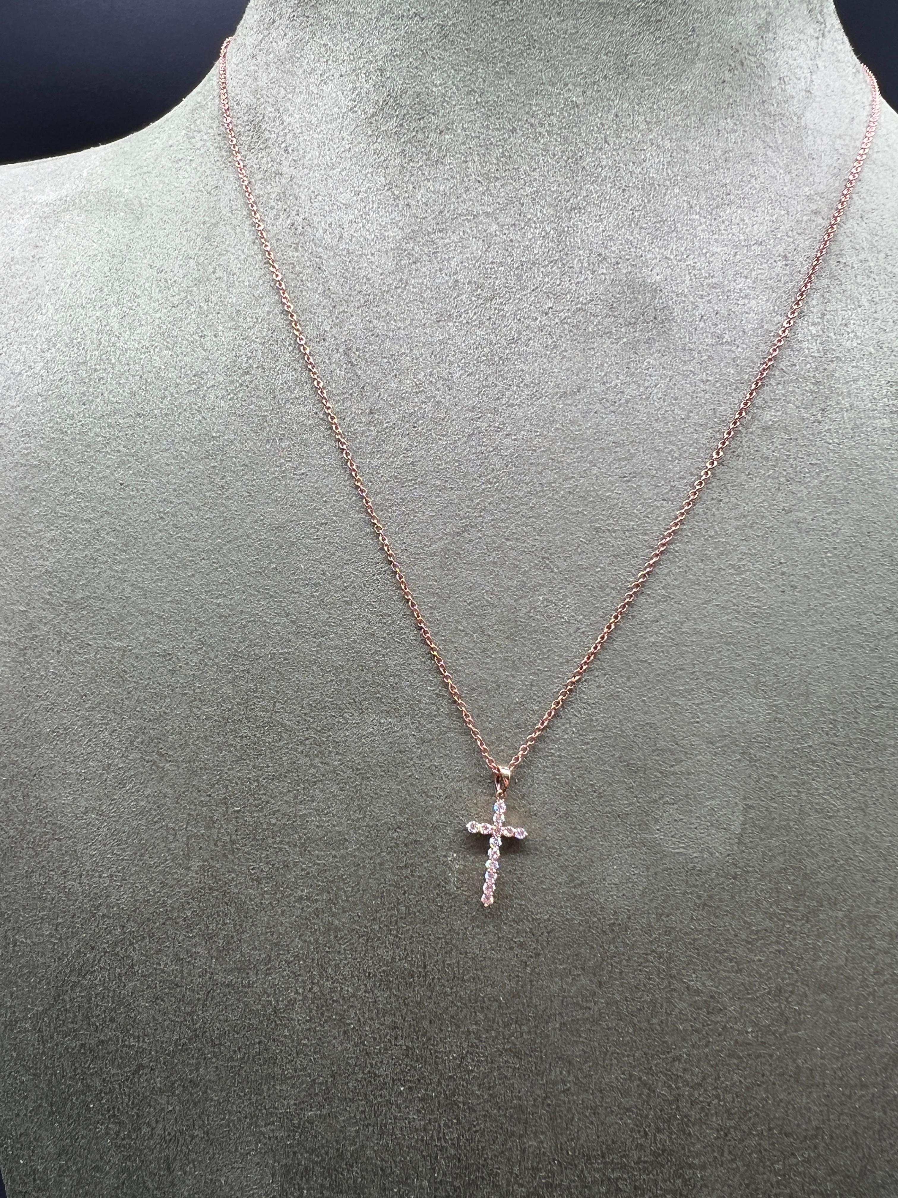 Pendent Cross Necklace Shape Diamond Pink Gold 

Necklace pendant in pink gold. 18 carats with a cross surmounted by 13 diamonds. 

Magnificent significant cross set with 13 brilliant cut diamonds. This necklace can be worn by the whole family and