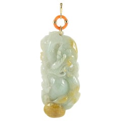 Gold pendant with orange coral ring and  bas-relief in Jade Nephrite