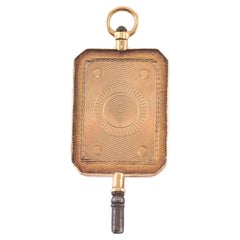 Pendente in oro con chiave da orologio