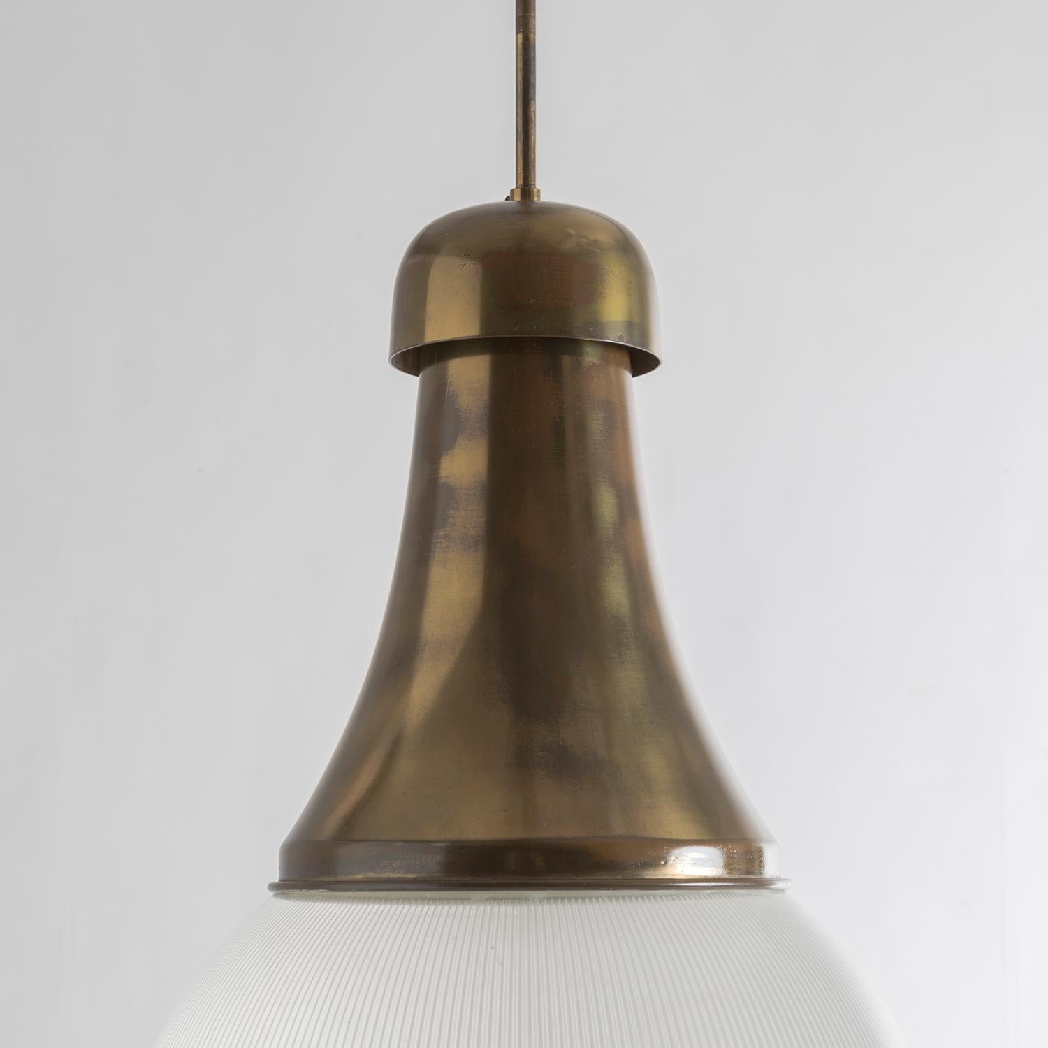 Elegant brass and molded glass pendant that appears to be a variation of the model designed by Tito Agnoli for O-Luce, excellent patina and good overall condition.