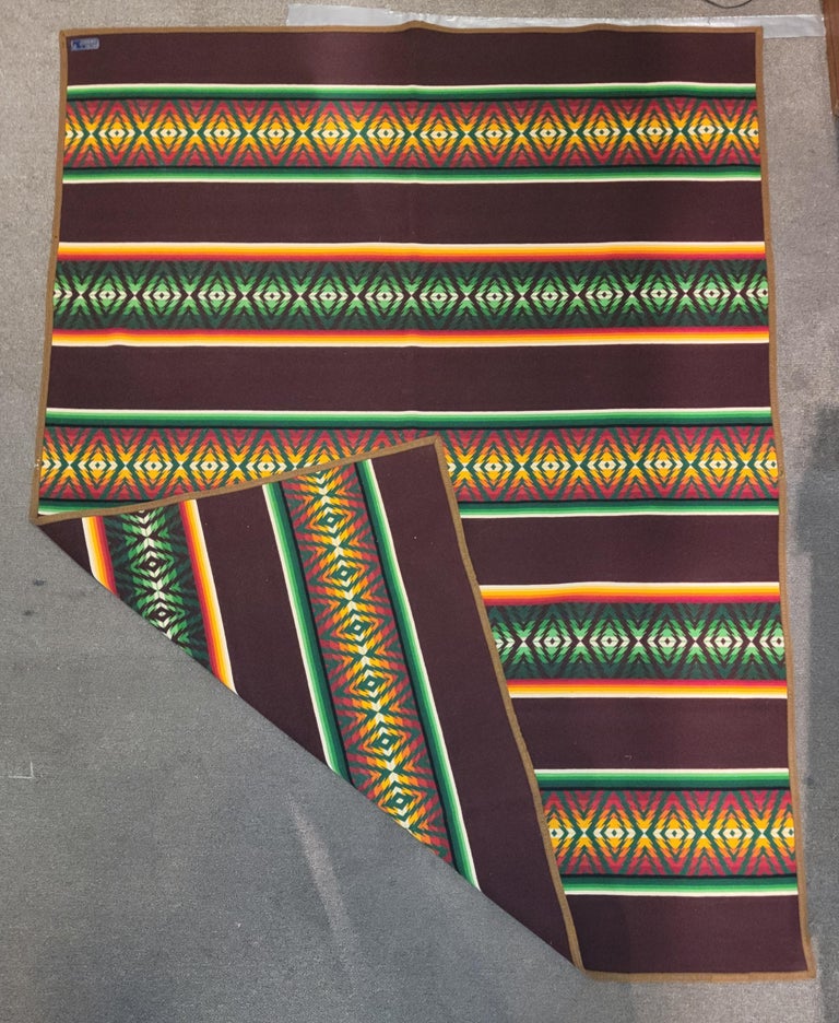 This amazing and most unusual wool Pendleton Indian design camp blanket is in fine condition.Minor wear on binding edge but not bad at all.It is a bars pattern or tree everlasting pattern with strong native pattern in the bars.It still retains its