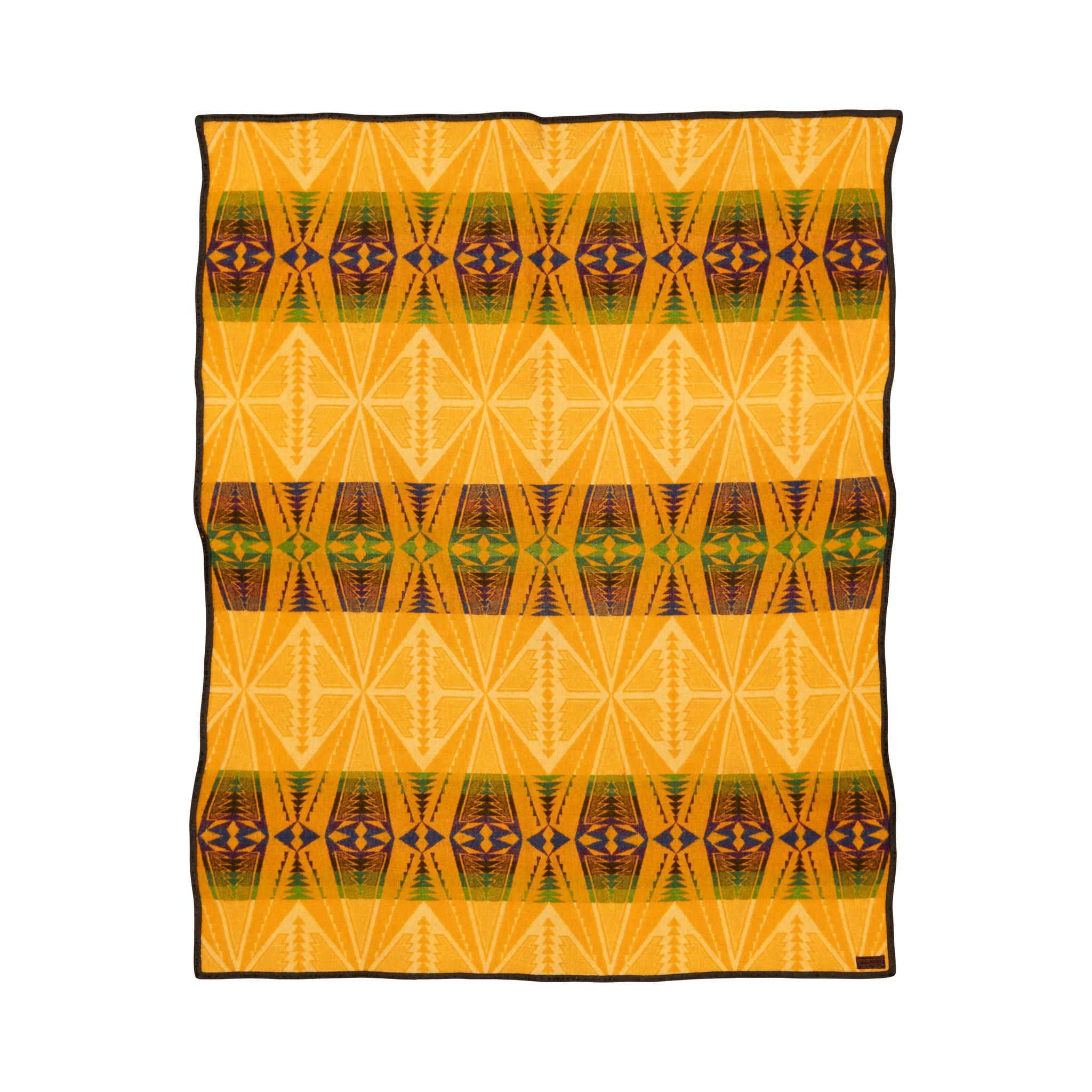 Pendleton Cayuse double sided wool trade blanket with label. Featuring bold yellow colors and large geometric patterns, with three bands having brown, orange and green coloring. Great for a Southwestern home or rustic cabin. Circa 1900. Size: 54