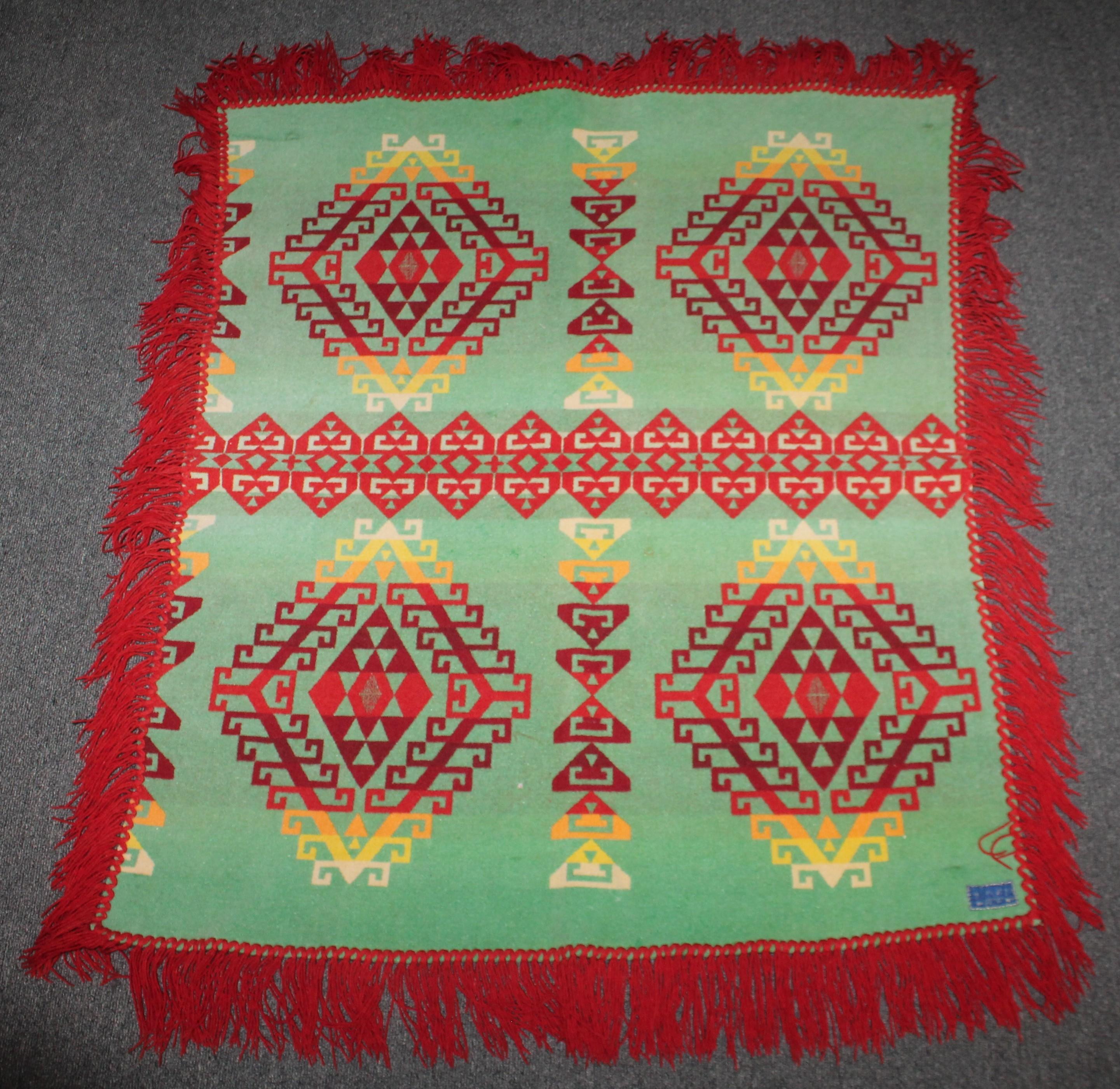 This fringed Pendleton Indian design crib blanket is in fine condition. It is double sided. It has the original label.