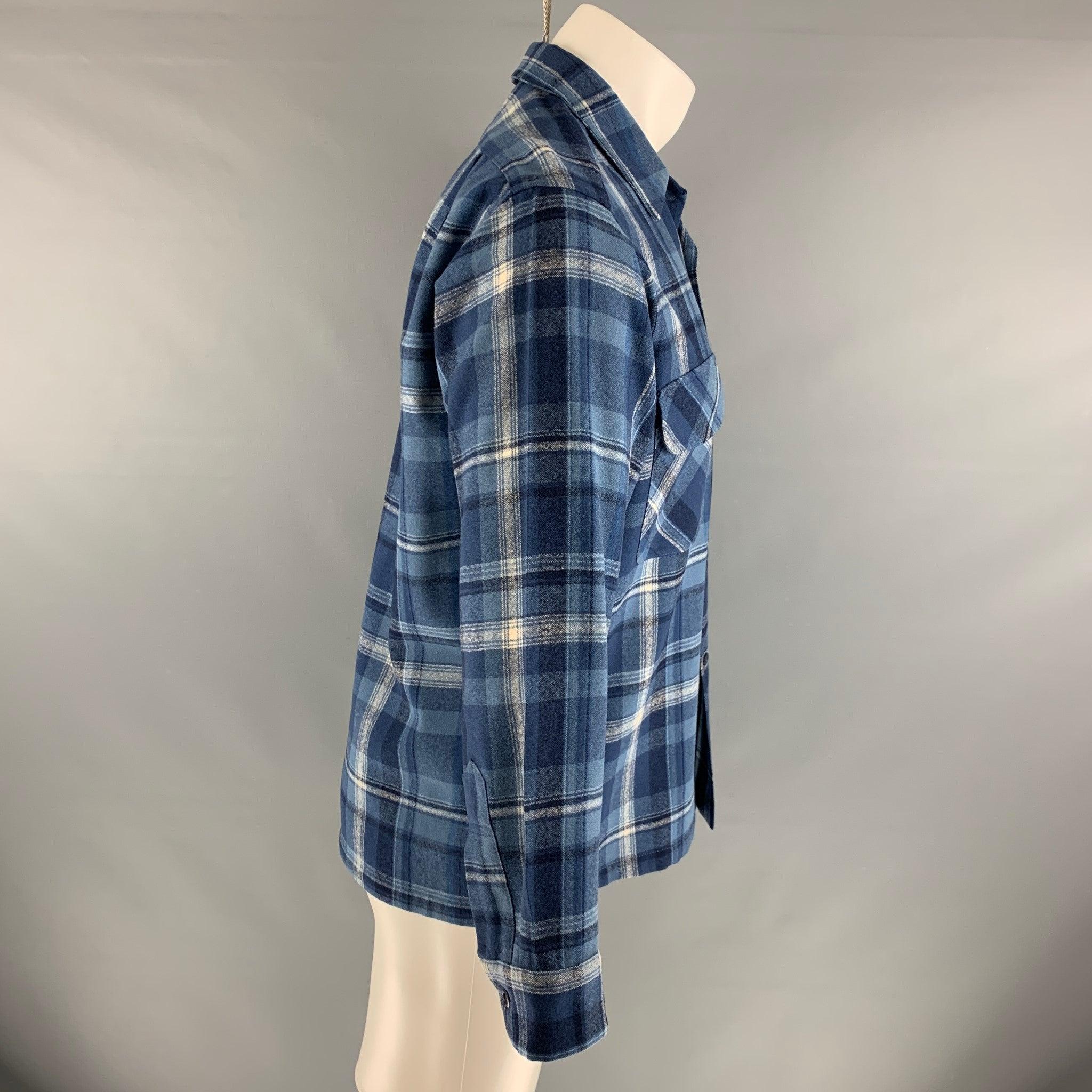 PENDLETON long sleeve shirt comes in 100% virgin wool, featuring patch pockets, a button snap closure, and a blue plaid design.Very Good Pre-Owned Condition. 

Marked:   M 

Measurements: 
 
Shoulder: 18 inches Chest: 42 inches Sleeve: 22 inches