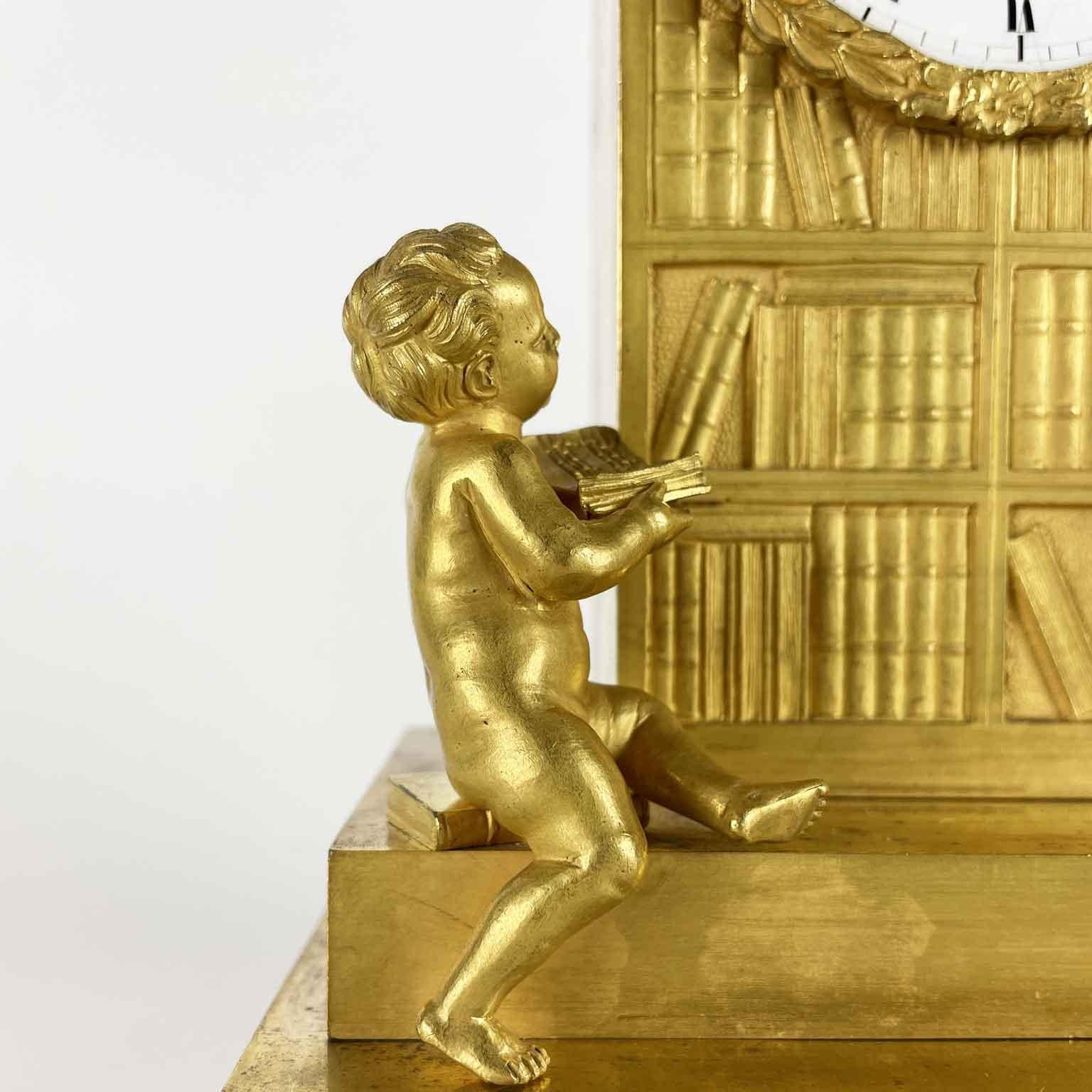 French Empire Pendulum In Gilt Bronze Early 1800s With Putti and Bookcase In Good Condition For Sale In Milano, MI