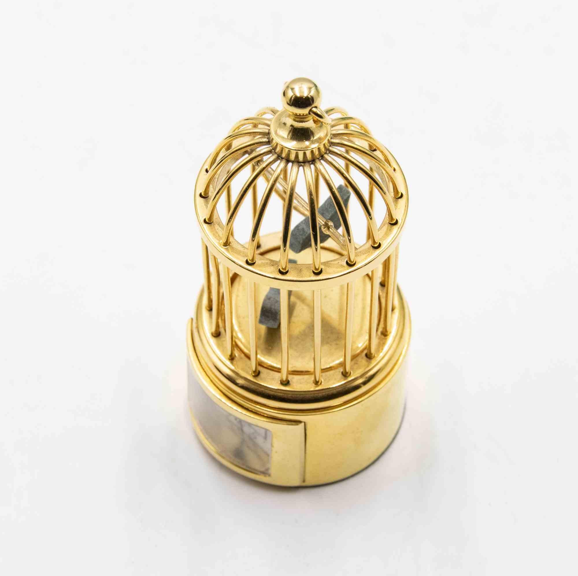 Very nice polished brass bird cage, with Bucherer mini mechanical clock.

In excellent condition, with its original box.