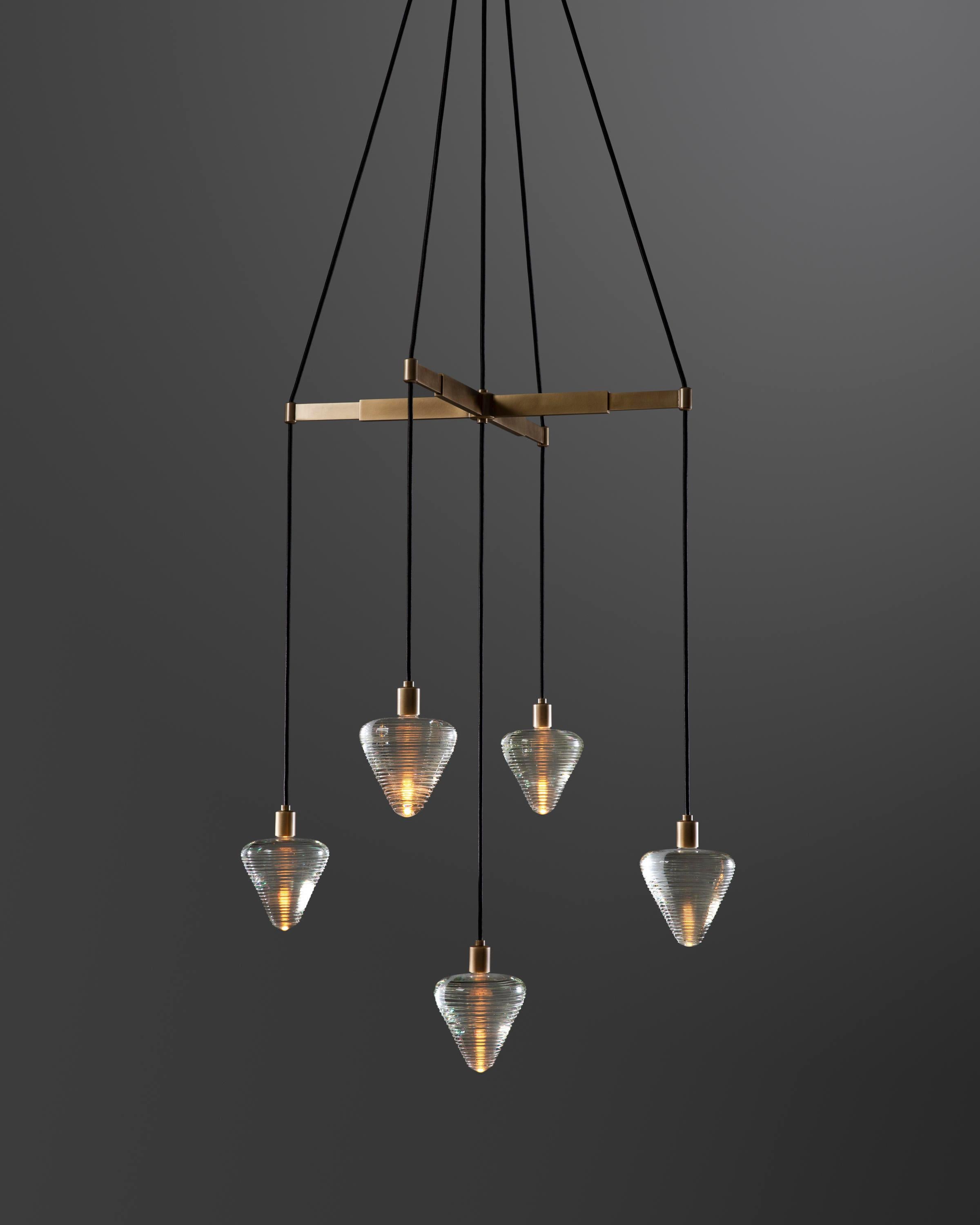 Galileo’s study of the pendulum – which ultimately led to the understanding of how to mark time – inspires the Pendulum Chandelier. The combination here of solid crystal that has banding applied to the outside with the light makes it feels virtually