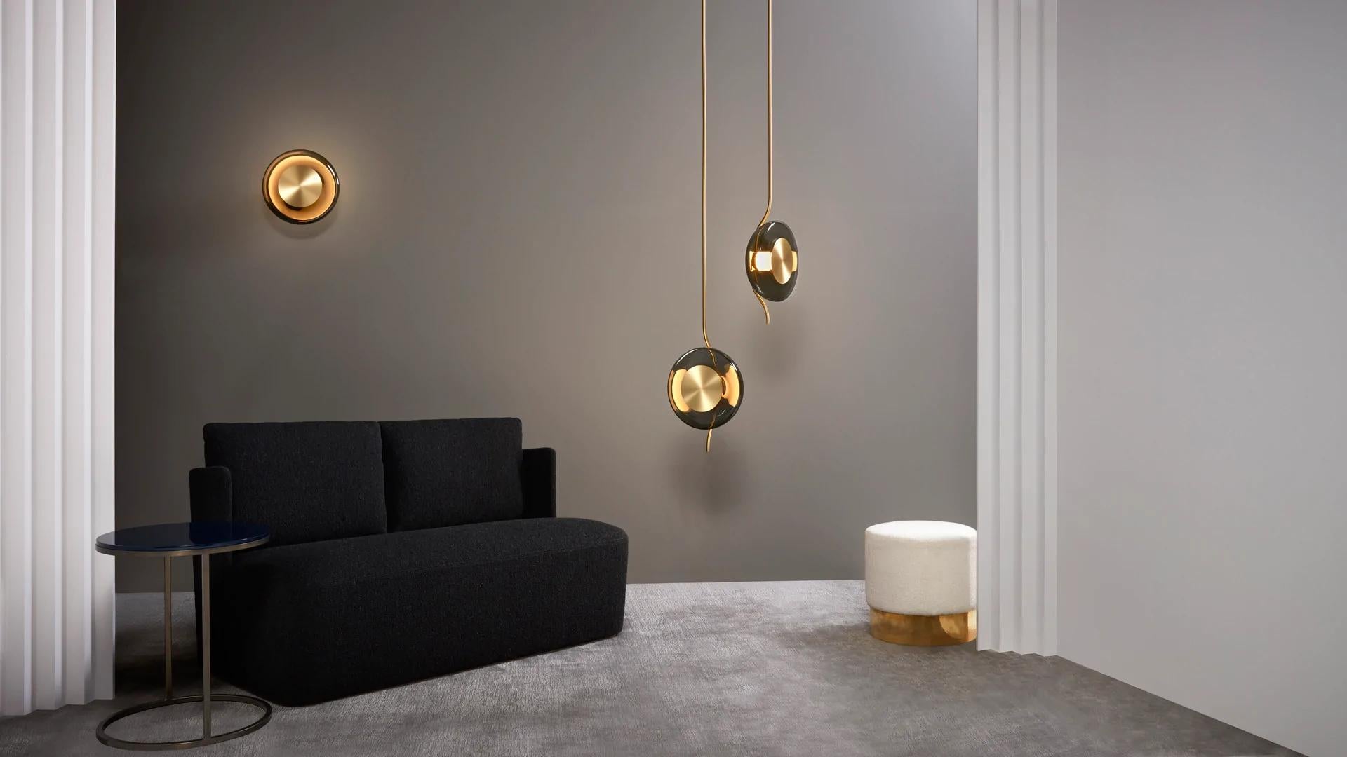 Pendulum pendant by CTO lighting.
Materials: satin brass with smoked glass shade.
Also available in bronze with smoked glass shade.
Dimensions: W 32 x D 15 x H 100 cm.

All our lamps can be wired according to each country. If sold to the USA it