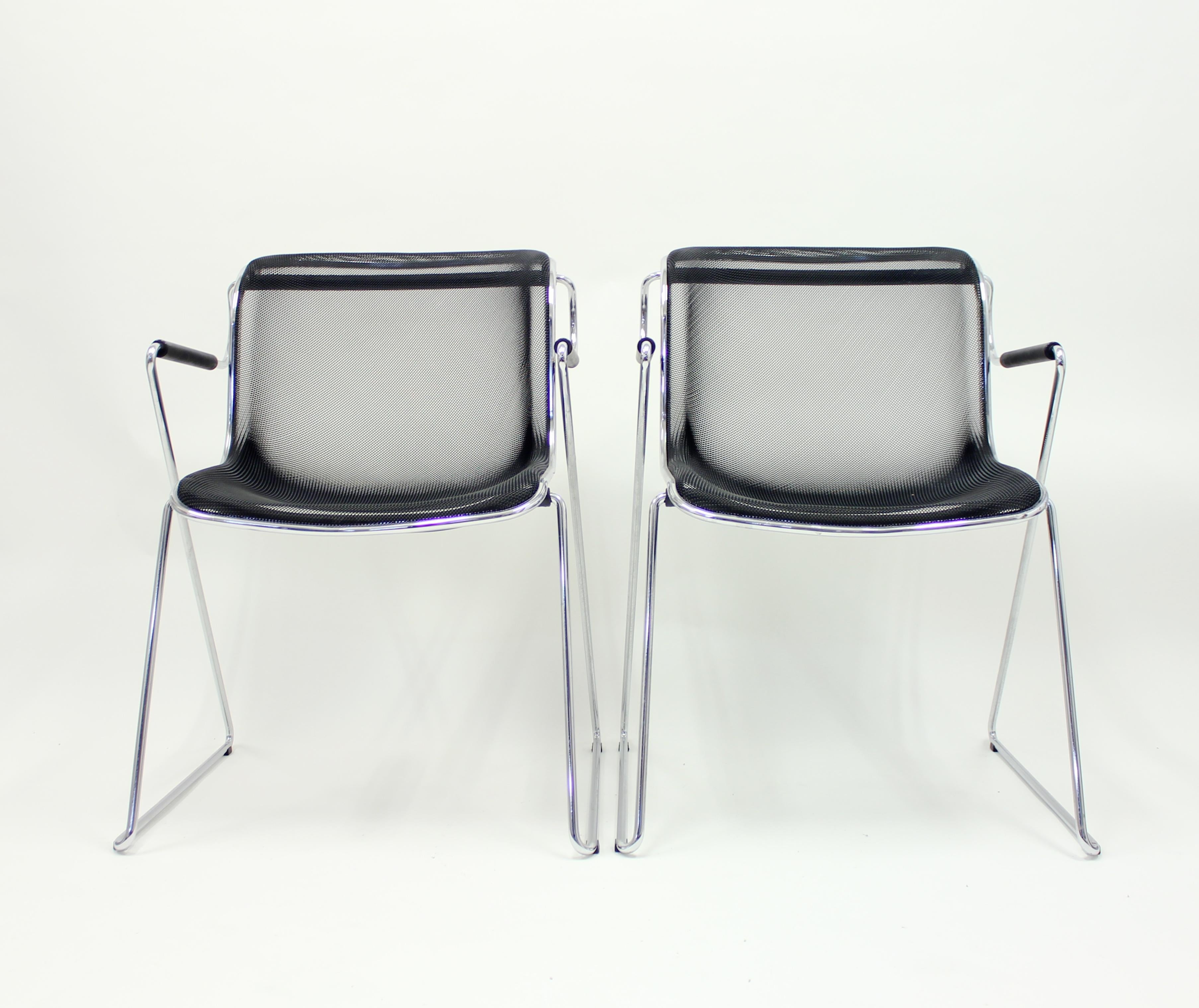 Pair of Penelope chairs designed by Charles Pollock in 1982 for Italian manufacturer Castelli. Tubular steel frame, rubber armrests and steel mesh seat. Stackable. The pair is in a very good condition with hardly any ware.
