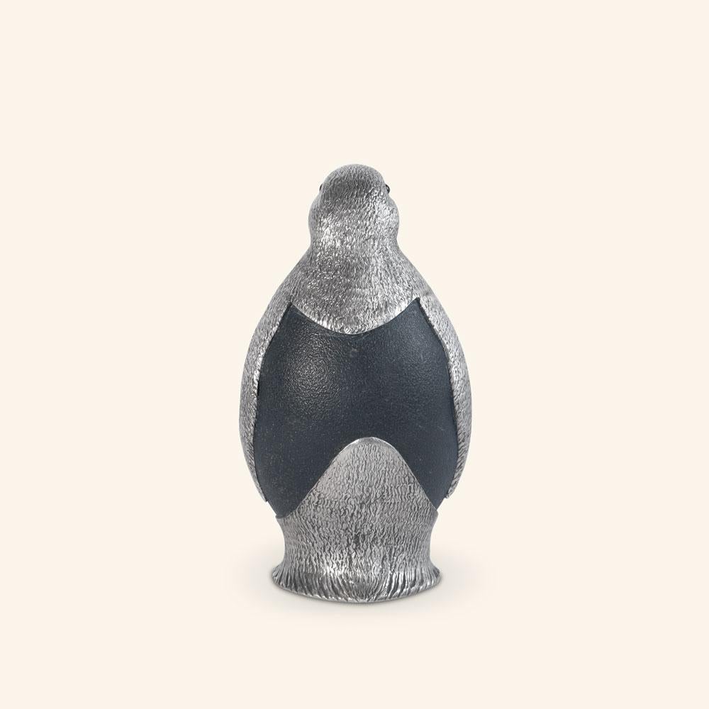 Penguin by Alcino Silversmith 1902 is a handcrafted piece in 925 sterling silver with ostrich egg application and black onix eyes.

This penguin is a contemporary sculpture made of chiseled silver plate applicated to the natural emu egg, is