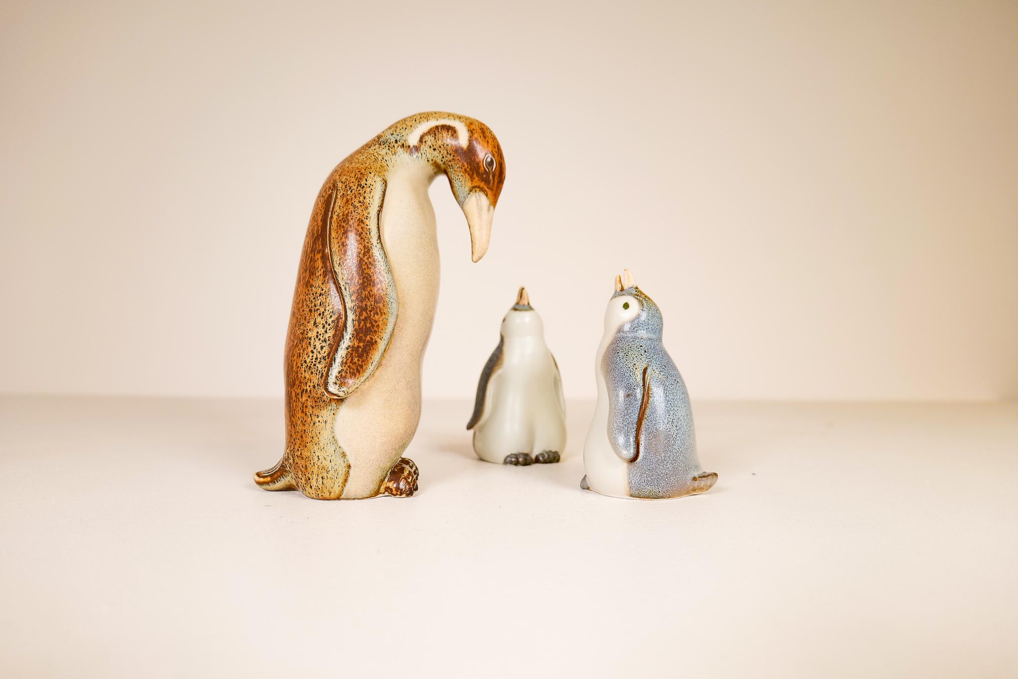 This set is 3 pieces of ceramic penguins from Rörstrand and maker / Designer Gunnar Nylund. Made in Sweden in the mid-century. Beautiful glazed and in good condition. One large and two baby penguins. 

The large one with glaze missing on the top
