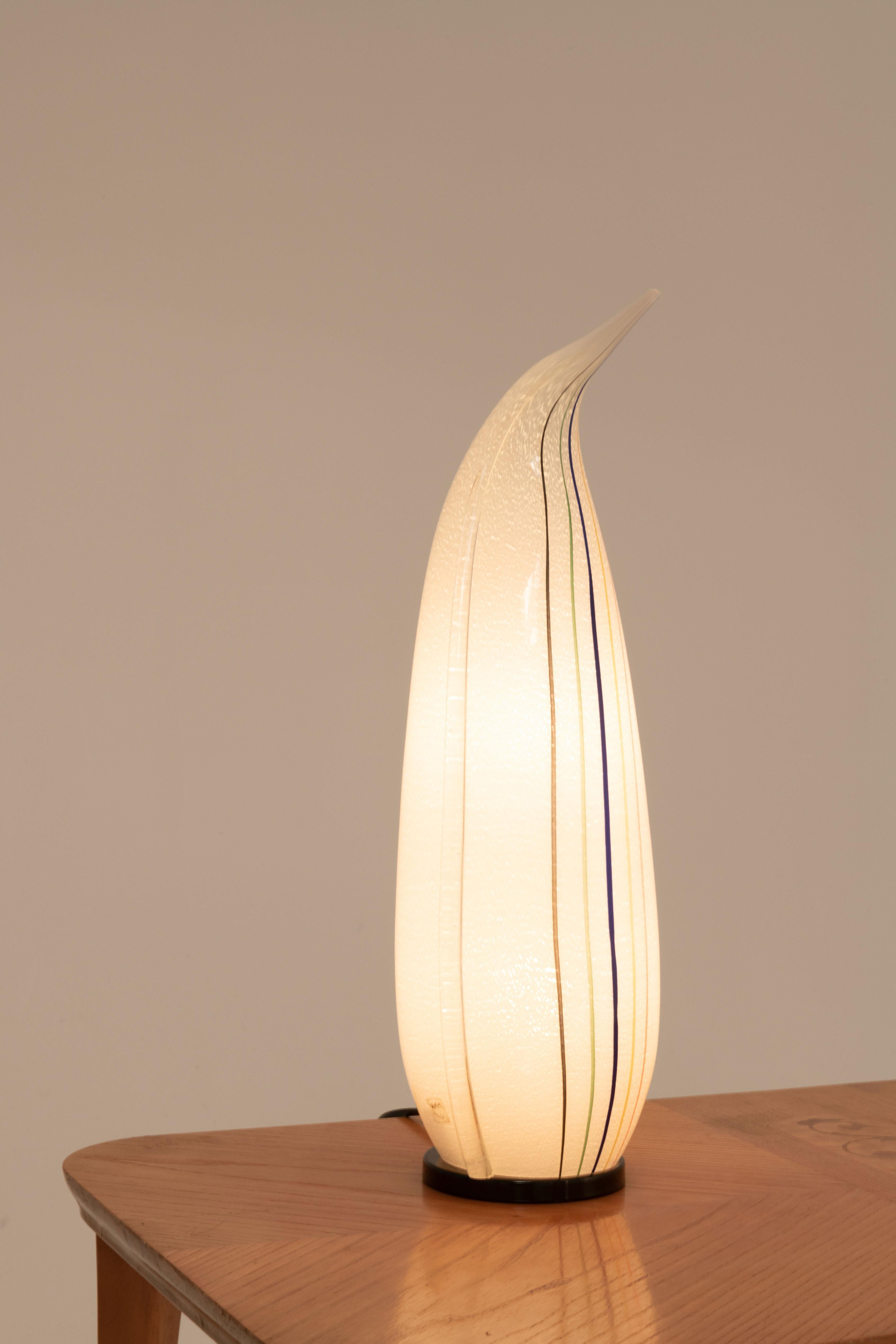 ​​​​​​​Here we have a penguin shaped lamp, manufactured by VeArt Murano. This specific table lamp differs from all the other existing models through its striped pattern. At the bottom of the lamp the manufacturer's mark can be found. 
VeArt, short