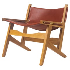 Peninsula-Loungesessel  Moderner Sling Chair aus Holz und Leder mit Messingdetails