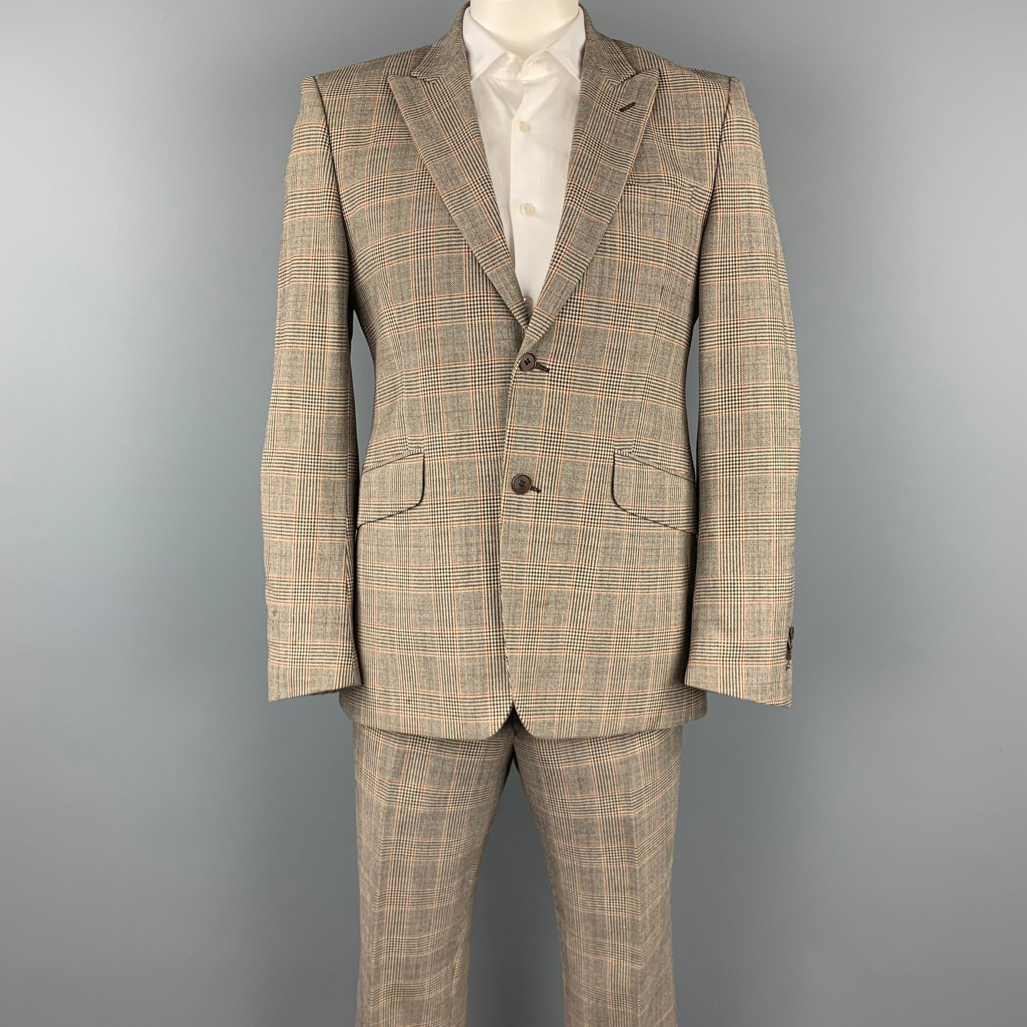 PENNESI suit comes in a regular brown glenplaid wool blend with a full liner and includes a single breasted, two button sport coat with a notch lapel and matching flat front trousers. Moderate discoloration. Made in Italy.

Good Pre-Owned