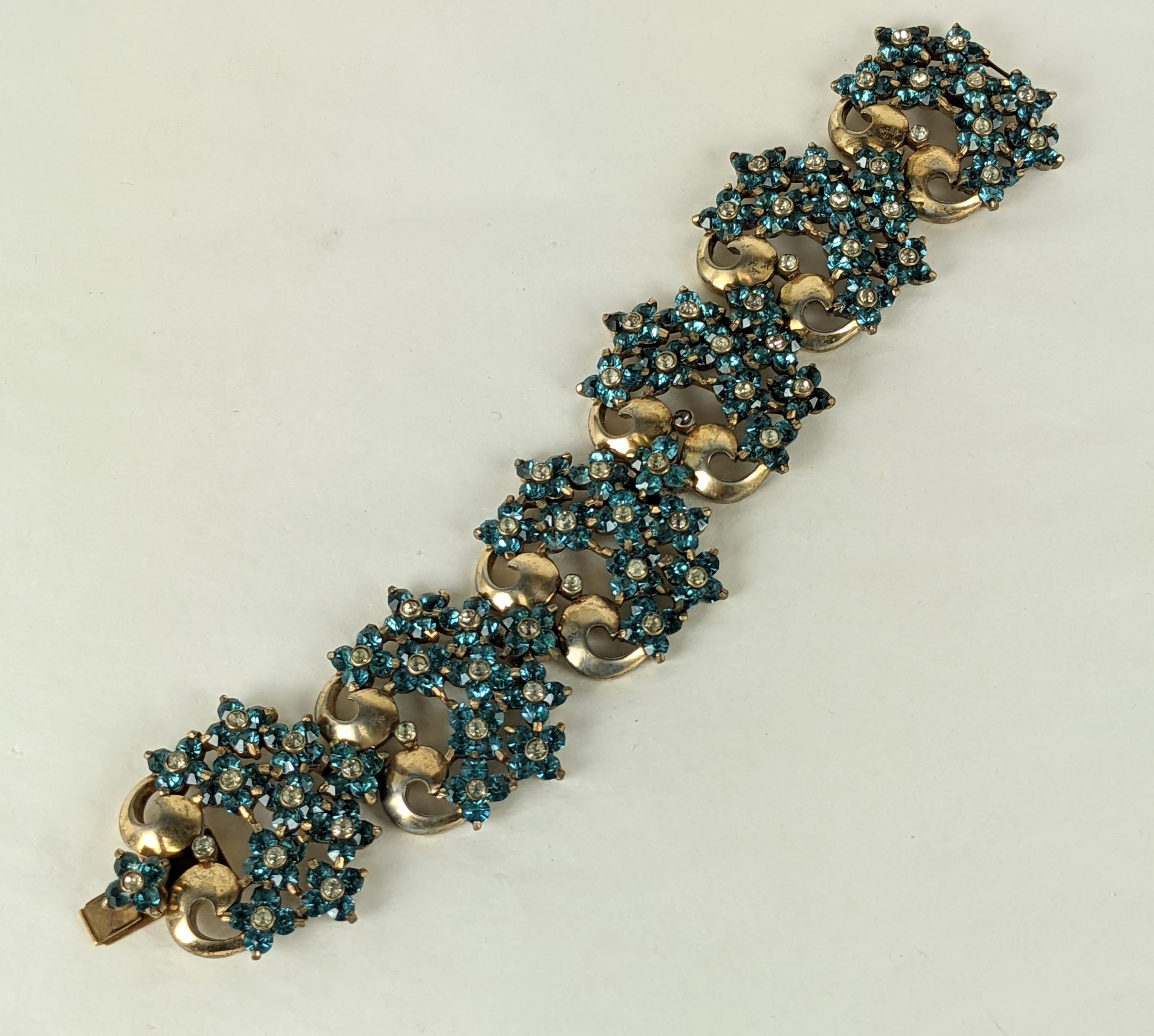 Imposing Pennino Retro Aqua Floral Cluster Link Bracelet from the 1940's. Clusters of deep aqua and crystal pastes are set on a scrolled floral links.  1940's USA. 
7